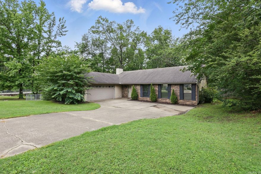 Charming 3-Bedroom Home with Office, Sunroom & Private Backyard Retreat!  Welcome to 2201 Carywood Drive in the heart of Bryant! This beautifully maintained 3-bedroom, 2-bath home offers approximately 1,816 square feet of thoughtfully designed living space, perfect for families, remote workers, or anyone who loves to entertain.  Step inside to find fresh interior paint and warm pre-engineered hardwood flooring throughout the main living areas. The spacious living room features vaulted ceilings that create an airy, open feel. A dedicated office offers a quiet space for work or study, while the bright sunroom is ideal for relaxing year-round.  The kitchen is a standout with sleek granite countertops and a layout that flows effortlessly into the dining and living areas—perfect for everyday living and hosting guests.  Enjoy the privacy and tranquility of a large, fully fenced backyard that backs up to green space—no neighbors directly behind you! Whether you’re sipping coffee in the sunroom or hosting a summer barbecue, this outdoor space is your personal retreat.  Located in a quiet, established neighborhood within the sought-after Bryant School District, this home combines