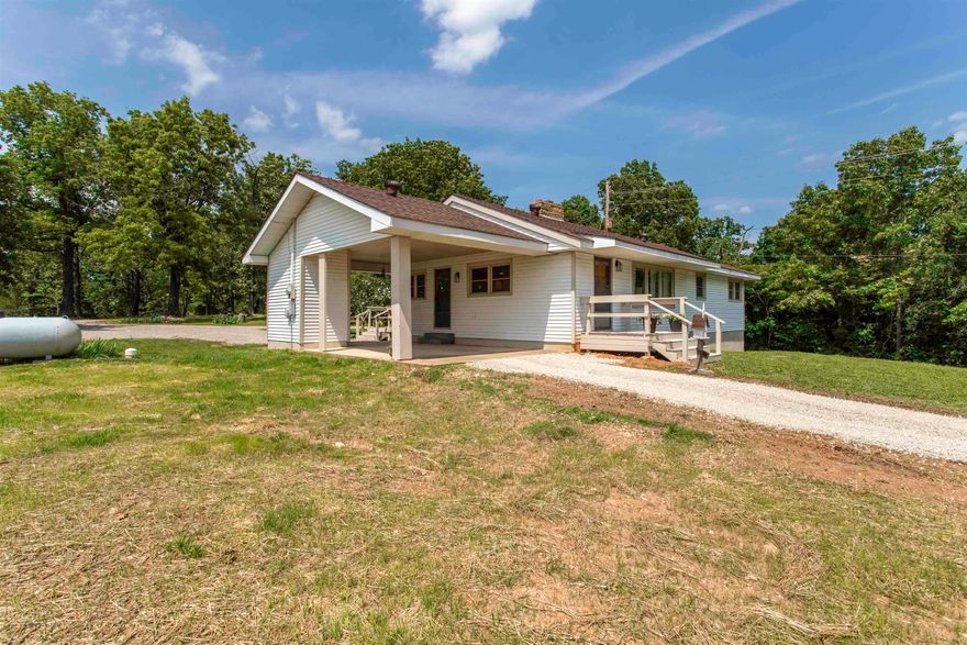 Charming Country Home in Hardy, Arkansas – Foothills of the Ozarks Perched on a gentle hilltop in the scenic foothills of the Ozarks, this inviting country home offers peaceful living with modern conveniences and stunning views. Set on approximately 2 ac with no restrictions beyond city ordinances, the property is zoned commercial/residential and sits right off the 4-lane hwy providing unique potential for home-based businesses or future development. city water and your own private well. The home features 3/2 w/1,344 sf main level, central air, gas heat, and a cozy wood-burning fireplace. A full poured-concrete basement (1,064 sf) unfinished heated and cooled with pull in garage, with a carport on main level and additional covered storage space. The circle drive offers ample parking and easy access. Step outside to find newly planted grass, mature shade trees in both front and back yards, three apple trees, a small garden, and a bounty of perennial flowers. Relax or entertain on the spacious deck just off the dining room. An 8x16 storage building is also included. This is a rare opportunity to own a versatile property in a beautiful, accessible location. Call for showing.