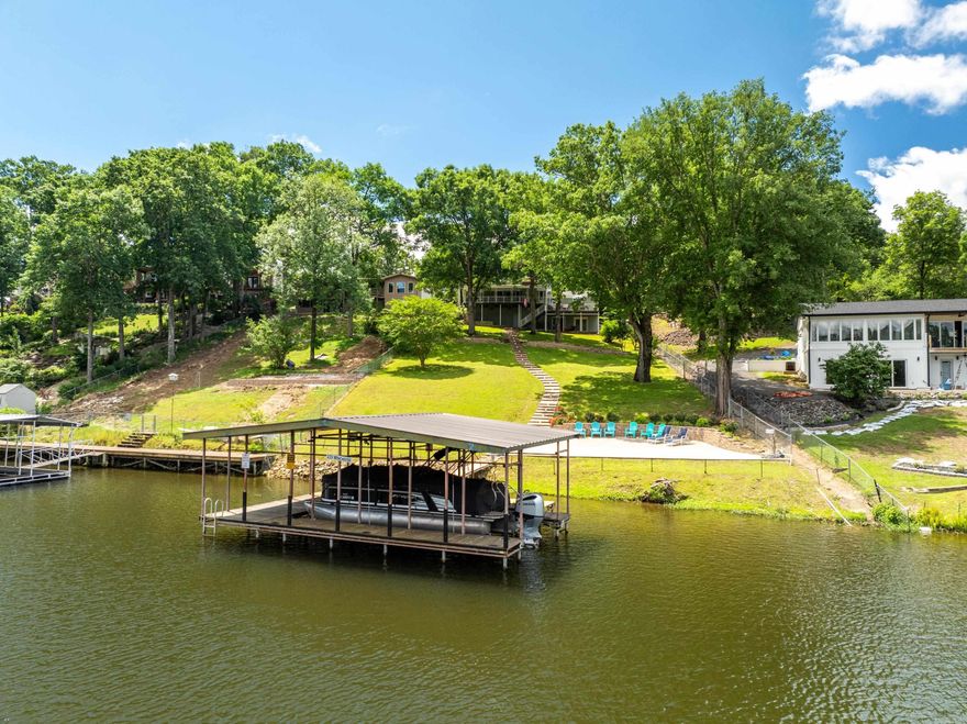 Get ready to fall in love with this incredible 3bd/3ba lakefront oasis! This stunning house features a massive lakeside patio for entertaining, where you can soak up the sun and enjoy the views.  The nearby covered boat dock with an electric lift and swim dock is the perfect place for all your water adventures.  Situated in a no-wake zone, it is the perfect place to kayak, paddleboard, swim or fish. All will enjoy the beautiful views and bird watching from the huge covered deck, or dining al fresco down below. This home is recently remodeled, and offered fully furnished.  Recent improvements include a new roof, gutters, newer HVAC, water heater, windows and electric. This home is move-in ready, and can be a turn-key short-term rental – no permit required in the county! There is a long list of recent upgrades and included furnishings.  Don’t miss out on this opportunity! (See agent remarks)