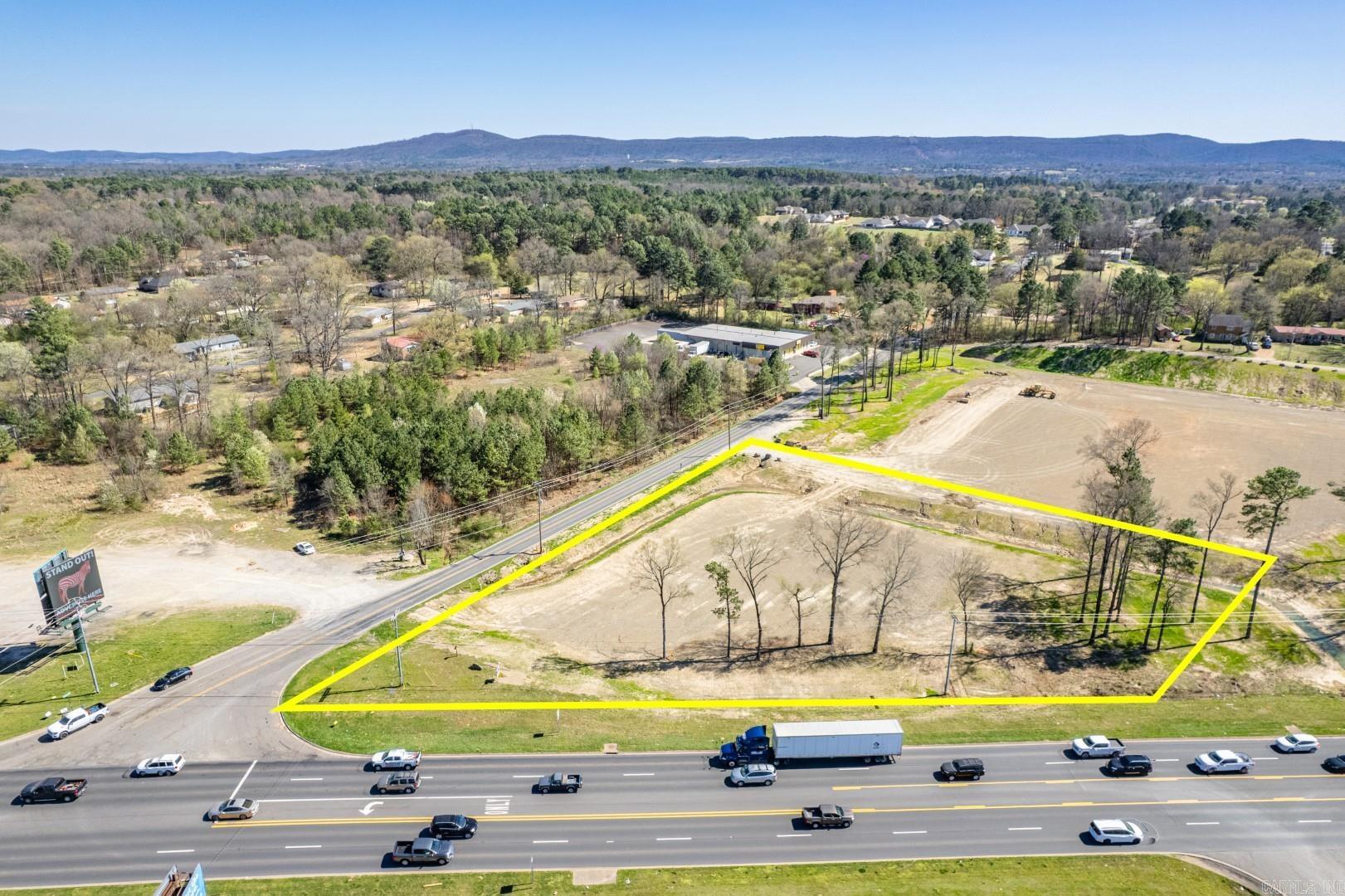 High visible stop light corner with 5 lanes and high traffic counts along busy US Highway 70 W of Hot Springs near Lake Hamilton schools and lots of residential roof tops. City utilities. Note: Additional land available for additional price.