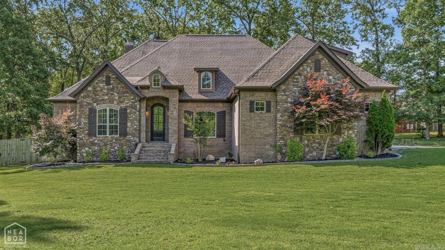 Tucked away on 1.6 beautifully landscaped and wooded acres, this stunning custom home offers the perfect blend of privacy, comfort, and timeless style. Built in 2014, the all-electric residence welcomes you with striking stone and brick exterior details and a warm, inviting presence from the moment you arrive. Inside, you'll find four spacious bedrooms and two and a half baths designed for both everyday living and entertaining. The living area features a cozy fireplace and custom built-ins, creating a perfect gathering space with character and charm. The thoughtfully designed floor plan includes a private upstairs bedroom and bonus room ideal for guests, a home office, or a playroom retreat. Outdoor living shines with both a covered patio and an additional deck, offering peaceful views of the surrounding wooded landscape and plenty of space to relax or host. A three-car garage provides ample storage, while a built-in safe room adds an extra layer of security and peace of mind.