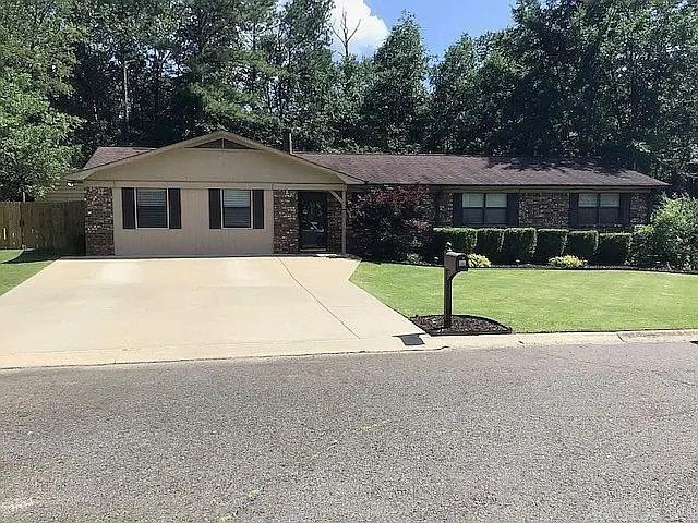 This single-story residence offers four bedrooms and two full baths, central heating and air, a wood-burning fireplace, and outdoor fire pit. The layout includes both a living room and a separate family room, plus a walk-in pantry. Conveniently located just moments from Lakeside schools, the Hot Springs Country Club, and the State Trooper's headquarters.