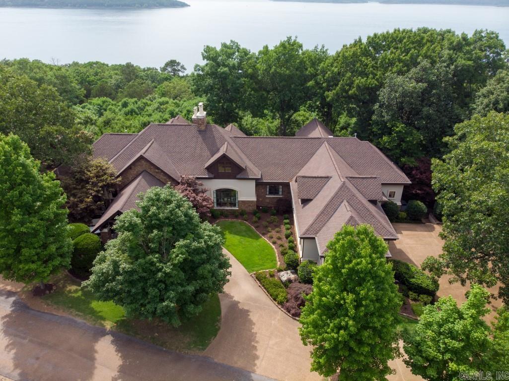 Luxurious Eden Isle FURNISHED home with incredible sunset views of Greer Ferry Lake! Built in 2002, and then completely remodeled in 2018, this exceptional home includes travertine floors inlaid with wood, marble counter tops, a very large master suite with lake view, fireplace, jet tub and walk-in shower. Viking appliances, screened porch with outdoor grill, spacious patio with great views and fireplace, bar area and wine cellar, office, 2-car garage, golf cart garage and much more! This property is in absolutely perfect condition! 5-minute golf cart ride to Eden Isle Marina!