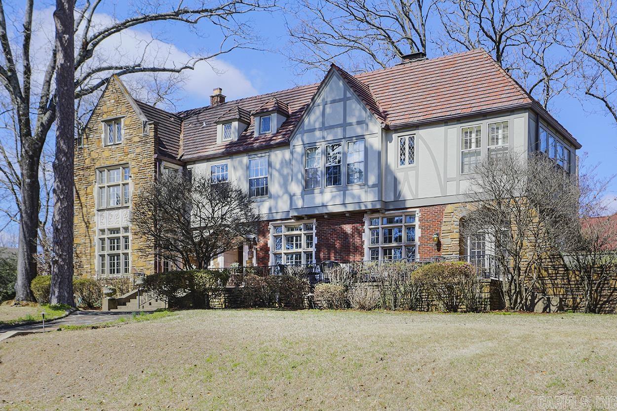 Absolutely spectacular English Tudor in the heart of Little Rock! This home is packed with elegance and charm and has been masterfully remodeled, keeping with the original architecture, adding custom stone countertops in kitchen and baths, all new appliances and custom cabinetry, eat-in kitchen, and custom bar with copper backsplash. The features are endless, with an oversize staircase, original stained glass windows and crown molding. Spanning three lots, this is a signature property, truly one-of-a-kind!
