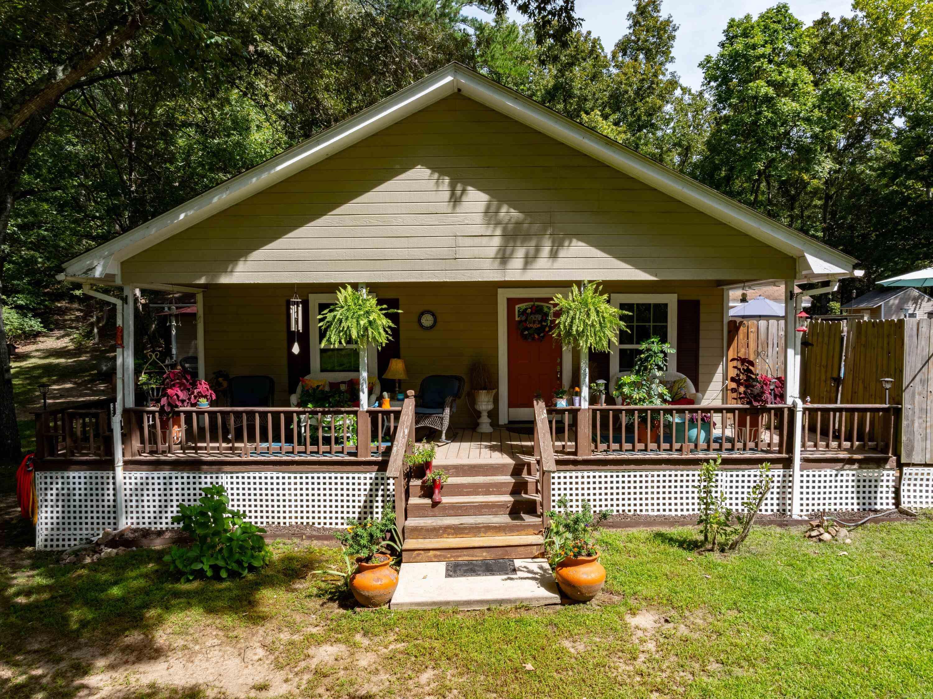 Charming and inviting, this cute home is nestled in the Deer Run Park area in Evening Shade, Arkansas.Offering cozy and comfortable living spaces both inside and out, this property is perfect for those who love the warmth of a welcoming home and the joys of outdoor living.As you approach the house, the wraparound front porch immediately gives you a cozy feeling, inviting you to sit and relax. Inside, the living room serves as the heart of the home, with two bedrooms conveniently located off this space.The large kitchen, complete with a dining area, is perfect for family meals, and the French doors leading out to an outdoor area provide the ideal space for entertaining.You'll find a bar, a screened-in porch, and a deck with an above-ground pool, making it perfect for summer gatherings.Off the dining room, a hallway leads to the laundry area and the spacious master bedroom. The master suite features a large master bathroom with plenty of space and a door leading out to a private deckāyour own personal retreat.The home has been well-maintained with several updates, including a 2-year-old heat and air system, ensuring year-round comfort.The septic system was pumped about 2 years ago.