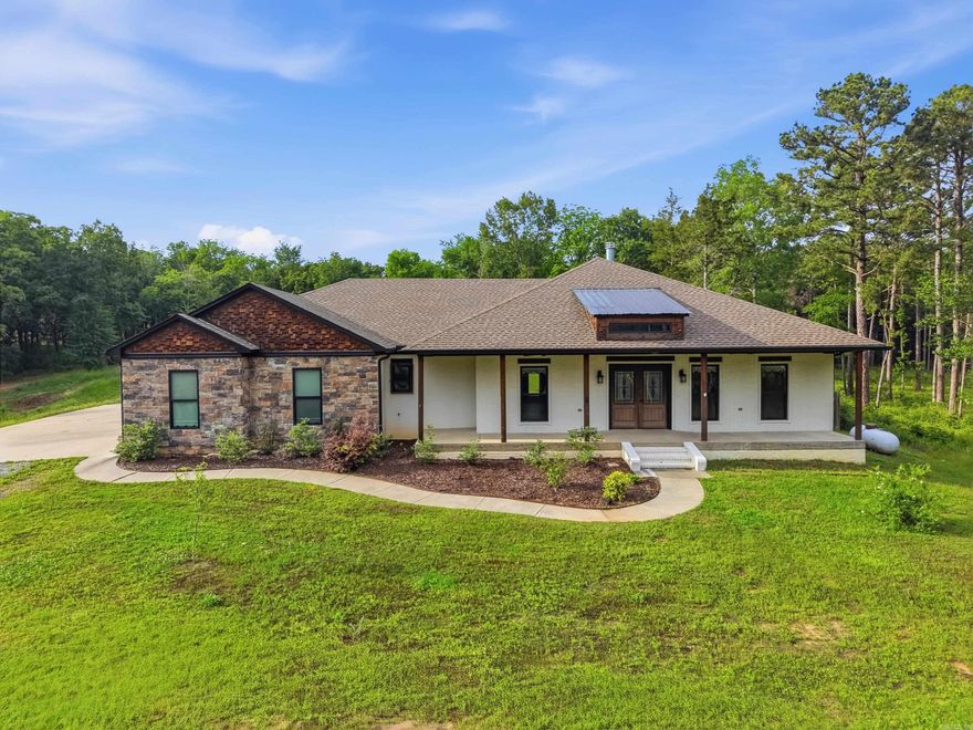 What a unique property! Situated on 2.24 acres just outside the city limits w/ two shops,including one w/ an 800 ft.² apartment.The main home features approximately 2,300 sq ft w/3 bedrooms, 2 baths & a dedicated office. A welcoming front porch leads to the spacious living area w/beautiful fireplace, opening into the dining space & stunning kitchen complete w/stainless steel appliances, copper farmhouse sink, tile backsplash, pendant lighting, large center island & walk-in pantry. The primary suite is generously sized w/spa-like bath & large walk-in tile shower, soaker tub, double sinks & spacious walk-in closet. Two additional bedrooms share a hall bath & separate office provides the perfect flex space. The 40x50 shop includes a finished apartment with 2 bedrooms, 1 bath, kitchen and living area, ideal for guests, rental income or multi-generational living. A second 30x40 shop with its own bathroom adds even more functionality for storage, business or recreational use. Enjoy the outdoors with a pond and plenty of open yard space, all just minutes from the Arkansas River and West Conway.