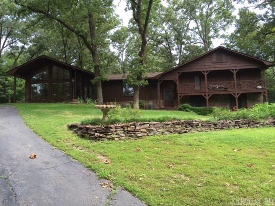 What a location close to Bass Pro. Gated entrance on the 4.75 acres. This 4 bdrm 3 full bath home has everything you need for the man or woman of the home. Large great room with vaulted ceiling, beautiful hardwood floors and walls, lots of glass windows, to enjoy your view. Formal dining, very large laundry room with a bonus area above it. 2 master suites to choose from. Updated kitchen with granite, an island and gas stove. Many other updates. Workshop w/storage, detached man cave/apartment w/kit & bath.