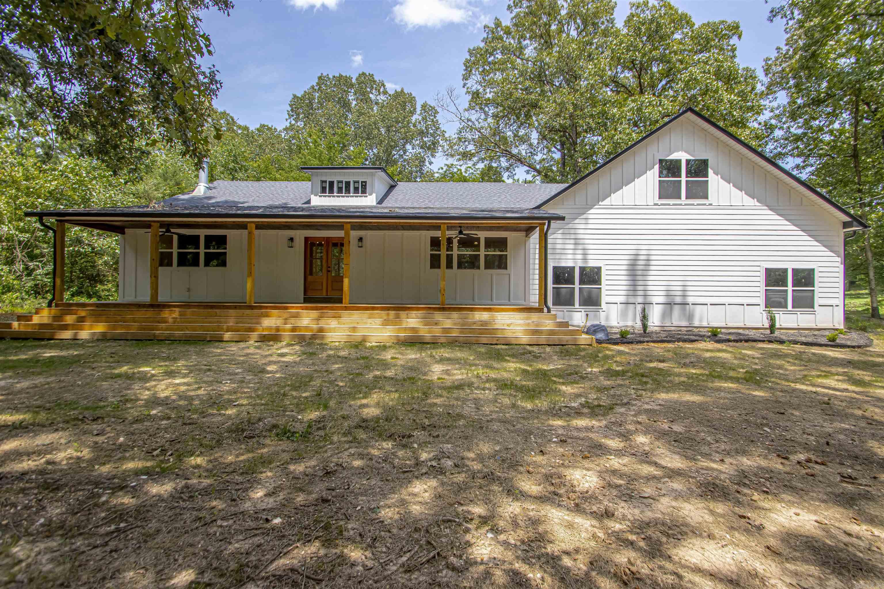 If you are looking for square footage and privacy then look no further!! This beautiful 4 bed, 4 bath home features 2 primary bedrooms, oversized garage with work space and storage, large bonus room, huge pantry, hardwood flooring and a well thought out floorplan. The left side of the home has been renovated down to the studs and the right side of the home is new construction with no expense spared to achieve that new construction quality throughout. Everything is only 2 1/2 years old including the septic system, city water supply (well still on the property), electrical, plumbing, HVAC, roof, interior finishings and concrete outside of garage (not shown in pictures). You are sure to love the private 2 acre lot that feels even bigger due to its seclusion and privacy provided by the large oak trees on the property. Enjoy country living at its finest while sitting on the huge front porch that features cascading steps, beautiful nature views of deer and other wildlife. This property also features a large shed and has plenty of room for a pool and a large shop!!