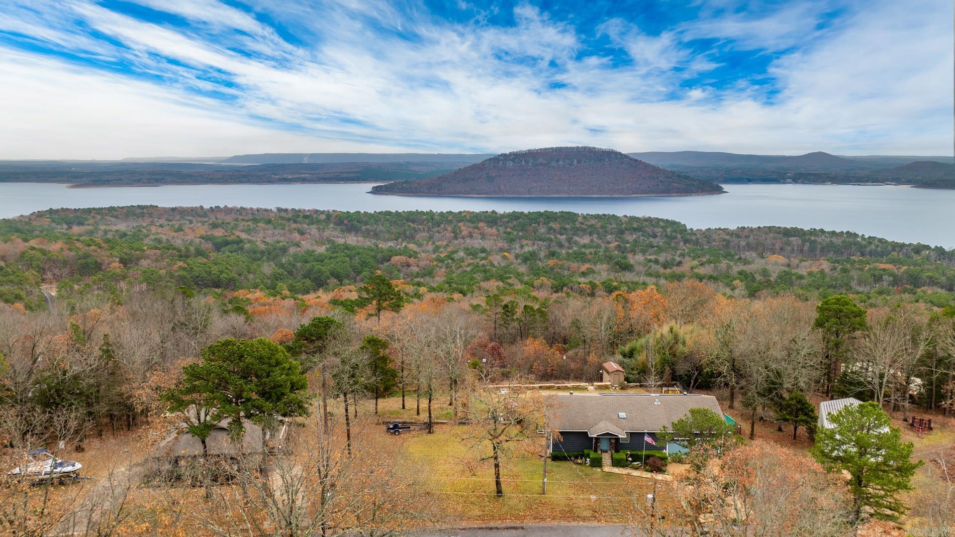 IS THIS THE BEST VIEW ON THE LAKE? Experience luxury living in this beautifully remodeled Lakeview home, where no detail has been overlooked. Pella windows showcase the breathtaking views of Greers Ferry Lake and Sugarloaf Mtn. Situated on 5 lots, this property ensures control over your stunning surroundings. Energy efficiency meets modern innovation with solar panels and a geothermal system, keeping bills remarkably low. A dramatic wall of windows spans both levels, flooding the home with natural light and maximizing views, while premium finishes throughout elevate the space to unparalleled sophistication. Don't miss the chance to own this exquisite hilltop retreat! Boat and Lift in boat slip convey at no value. Agents see remarks.