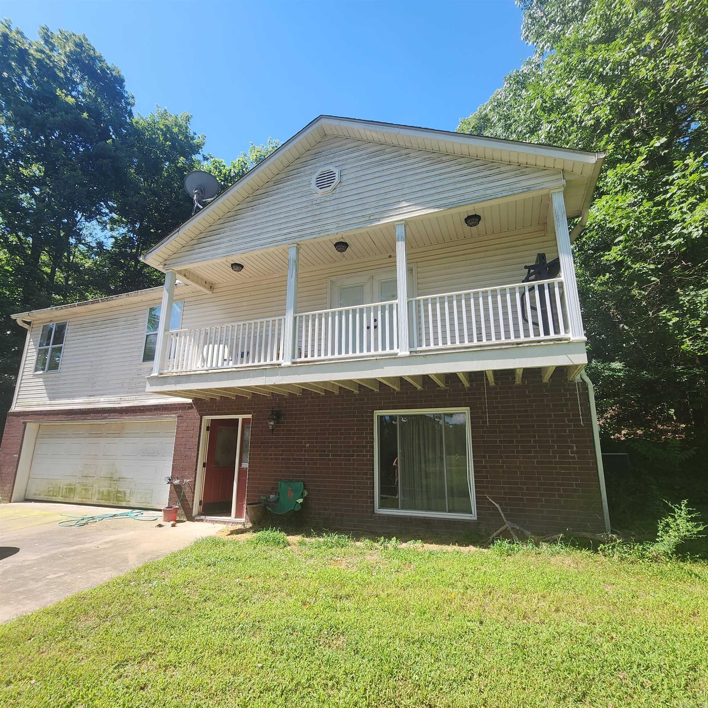 Split level home within walking distance to the famous "Little Red River". Main level offers 3 beds, kitchen, dining & living rooms. Lower level offers a great man cave with bar area or another bedroom if needed and a two-car garage. This home is a fixer upper and being sold "AS IS". Property will convey with a "Special Warranty Deed".