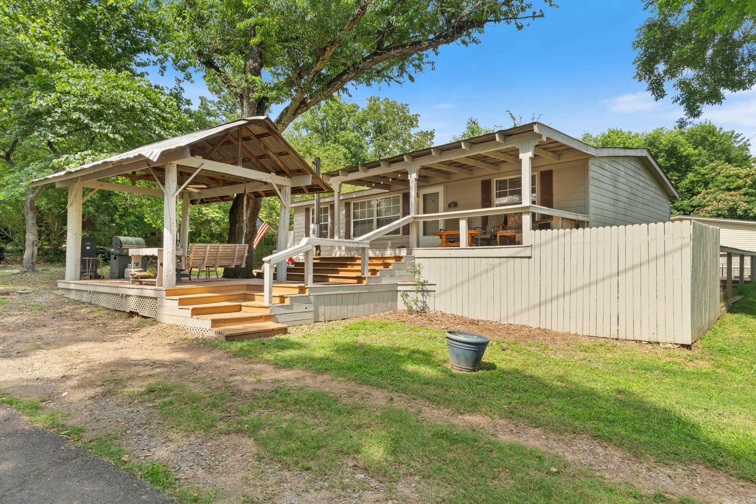 Whether you are looking for a home close to the lake, a weekend fishing getaway, or an airbnb; this 3/2 a short stroll from Lake Conway checks all the boxes! Tons of updates too: Garden Tub w Shower, some new windows, new paint and flooring, new faucet, new roof (2023), new metal skirting, new Hardie board siding, new foundation to qualify for FHA loan per seller, some new cabinets and counter tops, fenced deck, outdoor gazebo, storage shed, all appliances convey including washer and dryer! Ready for you to enjoy! Agents see remarks.