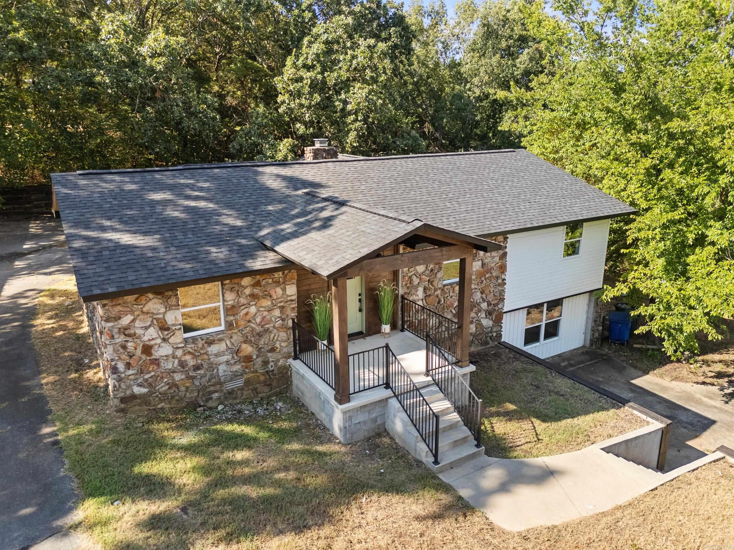 Enjoy golf course living in this fully remodeled home located in the premier heart of west Conway. All-new features include: -New roof -New electrical system -New HVAC system -New plumbing system -New flooring -New hardware -New deck -New cabinets -New appliances -Newly painted throughout Situated on an oversized lot directly across from the Conway Country Club, this property provides plenty of space for outdoor entertainment and play. The inside is spacious as well, with a large living area upstairs with a stone fireplace, a spacious dining area, a large master bath with walk-in closet, and over 500 square feet of entertainment space downstairs! Location, location, location....! This property is located in the highly desirable west side of Conway. It is within a 5 minute drive to much of Conway's best shopping and dining. It is a 3 minute drive to Julie Lee Moore Elementary School, and a 4 minute drive to Carl Stuart Middle School. Set up a tour today and see if this Conway gem could be your new forever home! *Living room listing photo has been virtually staged*