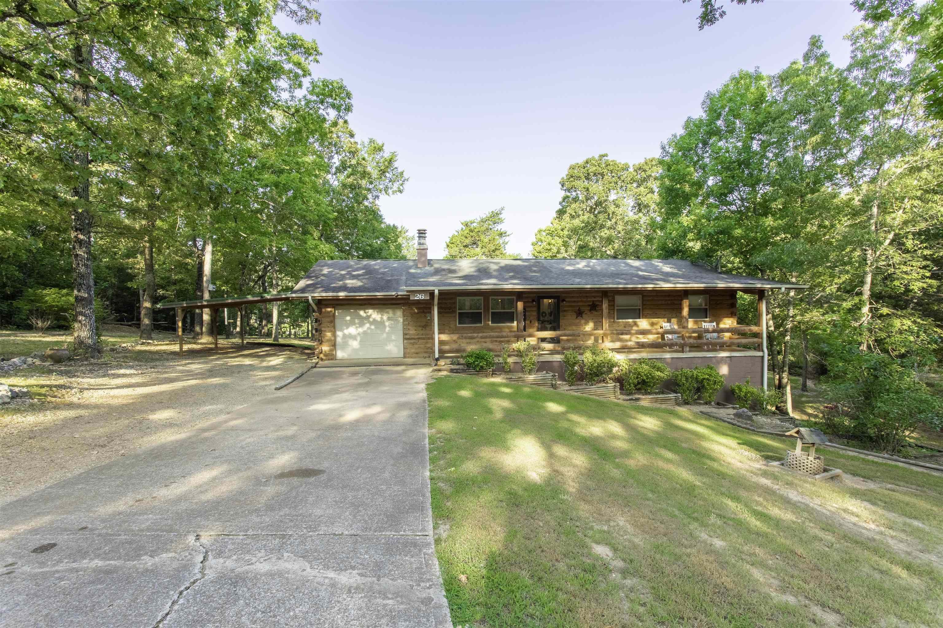 Lakefront Oasis on Lake Navajo – Cedar Log Home on 1.46 Acres in Cherokee Village Welcome to your retreat on Lake Navajo (34 acre lake) in beautiful Cherokee Village, Arkansas—nestled in the foothills of the Ozarks. This recently renovated cedar log-sided home sits on three lots totaling 1.46 acres & offers the perfect combination of rustic charm and modern comfort. Boasting 254 ft of serene lake frontage, this 3-bedroom, 2-bathroom home is an ideal escape for nature lovers, water enthusiasts, or anyone seeking peaceful, scenic living. Enjoy your morning coffee or evening glass of wine from the waterfront gazebo, your private boat dock, or the sunroom and back deck off the master suite—each offering breathtaking views of the water and wooded surroundings. Inside, the open-concept layout features clean white walls and updated finishes, ideal for relaxing or entertaining. The full-length covered front porch adds to the home’s welcoming charm, while the enclosed garage, two-car carport, and 16x32 basement workshop provide ample space for vehicles, tools, and hobbies. The HVAC system replaced 2019 w/ propane gas backup for year-round comfort. Scattered shade for a park like setting.