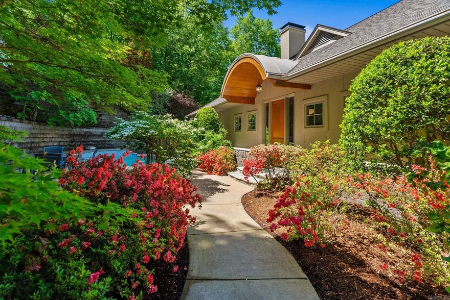 This spectacular custom-built home is an oasis in the middle of Little Rock with sweeping views of the Arkansas River from October through March. A rose-covered trellis welcomes you into this entertainer's dream with a beautifully landscaped swimming pool featuring swim jet and an intrinsic waterfall, all framed by shady trees. Open concept living and dining areas with floor to ceiling windows and gorgeous fireplace flow effortlessly into soft contemporary kitchen, with an expansive pantry/laundry room. Handsome study on the main level with fireplace offers a quiet retreat. There are 3 bedrooms and 3.5 baths in this exquisite home. Oversized main level primary suite features spa-inspired bathroom, luxurious closet and finely crafted spiral staircase leading to a serene third floor reading room and rooftop deck, perfect for stargazing or sunset views. Downstairs are two large bedrooms and living area. This immaculately cared for home also includes a whole-house generator, new 2022 roof, true stucco and rock exterior, cedar closet, workshop, outdoor shower and generous parking. Come see this one-of-a-kind beauty!  *Agents please see remarks.