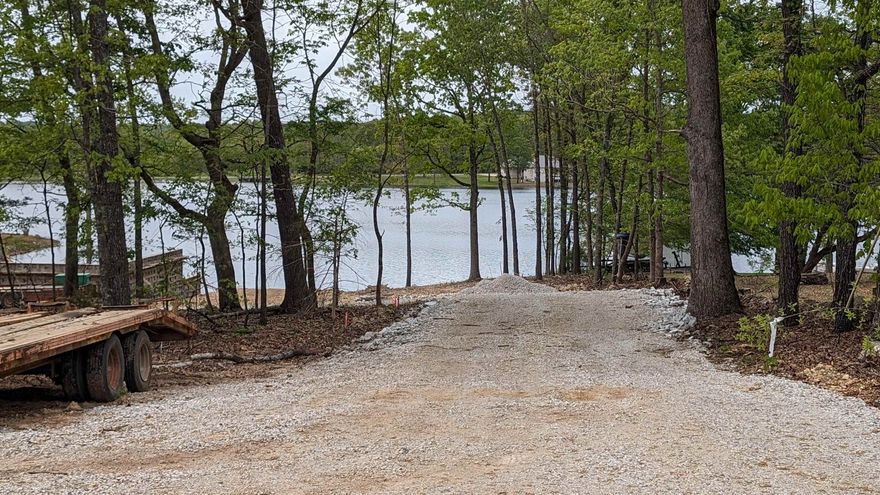 Undeveloped lot across from 640 acre Crown Lake. Good view down the driveway across the street. Level Wooded lot. Utilities available at the street but a septic system would be required if building a home. Property ownership includes access to other lakes in Horseshoe Bend plus community amenities like the golf course. See D-documents for restrictions in bills of assurance.