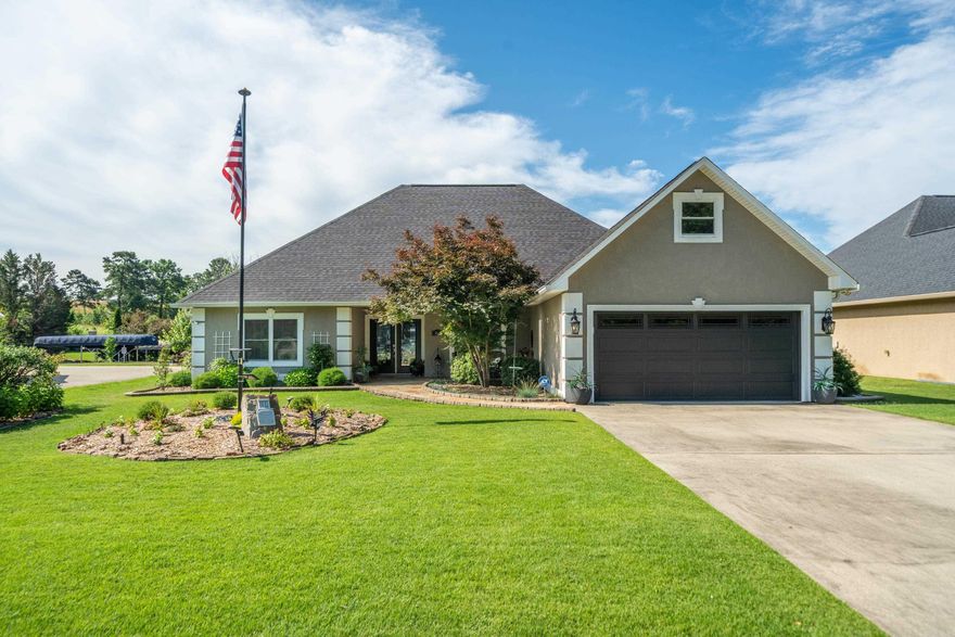Location, location, location! This beautiful lake home is the epitome of lake living. Located on a small cove, this lake area is a great spot to fish, swim and park yyour boat without the beating of the waves on the main channel. The grand entrance into an open floor plan living space facing the lake with large windows, provides you beautiful lake views all day. High ceilings and decorative tile floor greet you as you enter the home. Split floor plan separates the bedrooms for more privacy in the primary bedroom.  All the bedrooms have new carpet that was replaced in 2022 with lifetime carpet pad.  The primary bath has a jacuzzi tub, step-in shower, double vanity sinks and 2 walk in closets.  The kitchen has new Cambria Quartz countertops with lots of room to cook your favorite meals. The 2 guest bedrooms are larger than expected with one having direct access to the bathroom.  Guest bath has double vanities and a new oversized step in shower. All windows have custom fit vinyl blinds.  Step out back to an immaculately cared for back yard and porch. The natural stone walkways and porch are calling you to sit and enjoy your favorite drink as you enjoy the gorgeous sunset views.