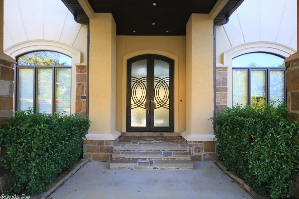 Beautiful Chenal contemporary in gated neighborhood. Two story entry into formal living w/FP & formal dining. Large separate master suite with his & hers baths & closets, bonus/gym & walk thru shower. Large hearth room, guest suite, laundry, office, storage/pantry, office/craft/playrm & dining also on main. Cook's kitchen w/breakfast bar & eating area. Upstairs are 3 bedroom suites, game room, wet bar, media room & bonus area. Outdoor fireplace, sports court and wooded backyard. Come see!