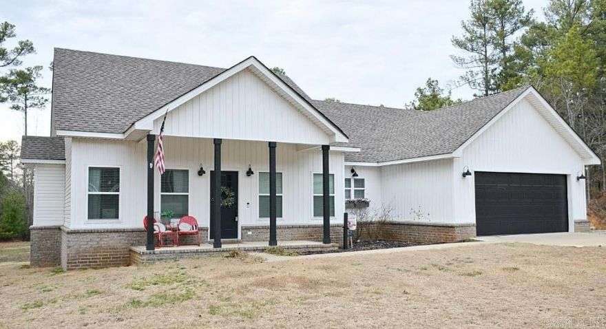 Welcome home to contemporary comfort and serene country living! This beautifully maintained 3-year-old residence built in late 2021 sits on an expansive 1.72+/- acre lot in a secluded area just outside Jonesborowhile still being only a 10-minute drive from the charming towns of Jonesboro, Brookland, and Paragould positioning it in the Brookland school district. Walking onto this absolutely CHARMING front porch is just your first step to discovering what's inside this thoughtfully designed, open concept living space featuring luxury vinyl plank flooring throughout, which seamlessly connects the inviting living room to a dining area perfect for entertaining. The gourmet kitchen is a delight! Talk about cabinets galore showcasing these gleaming granite countertops, stainless steel appliances including a double oven, and an oversized pantry complete with even more counter space and ample cabinetry for storage. With three generously sized bedrooms and two well-appointed bathrooms, this home offers both privacy and comfort. The large laundry room provides convenient access to the walk-up attic space, ensuring plenty of room for storage and organization.