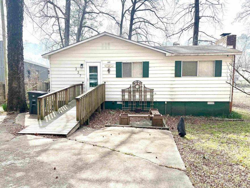 Welcome to this beautiful double lakefront property offering the perfect retreat for life on the water.  Inside, you'll find 2 comfortable bedrooms and 1 full bath, along with convenient stackable washer/dryer.  One of the bedrooms features its own sunporch- an ideal spot for morning coffee or relaxing with a view.  Step outside and enjoy everything Lake Hamilton as to offer, including a private dock, swim platform with a ladder, making it easy to spend your days swimming, boating or simply soaking up the sun.  There is also a covered area that could accommodate an RV or trailer, providing additional flexibility for guests or storage.  Recent updates include LVT flooring and roof was replace in 2012.  If you're looking for a place to unwind and truly enjoy lake living, this lake house is a must-see.  Come experience all it has to offer and make the most of your time on the water.   SOLD AS IS CONDITION.  AGENTS see remarks.