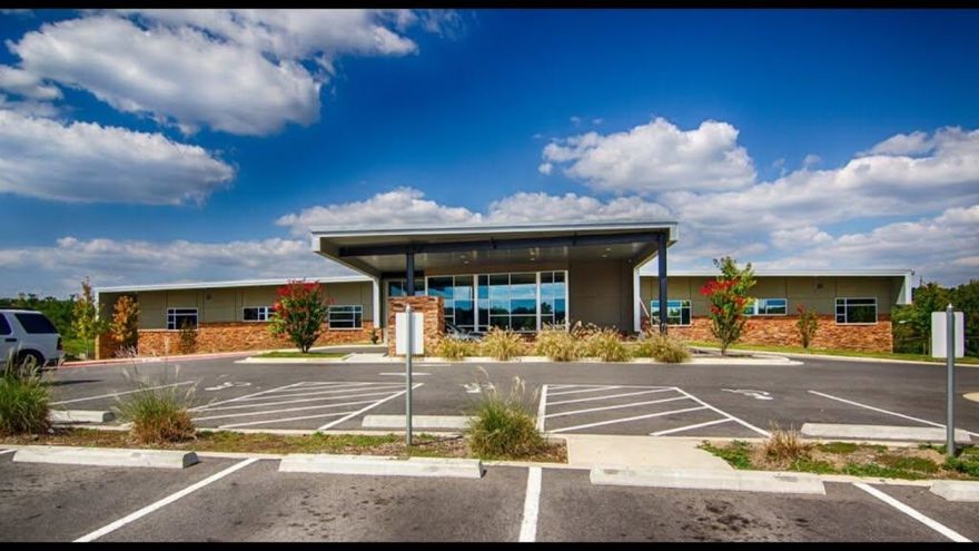 Office Building For Sale - This modern building is situated on nearly 2.25+/- acres of prime real estate, located in a highly visible area right in the heart of Hot Springs. With two expansive levels with each offering more than 15,000 sqft+/- of space. The first level includes offices, board rooms, waiting areas, hallways, break rooms, and 8 restrooms, providing ample amenities for a productive work environment. The lower level remains unfinished, presenting a blank canvas for new owners to customize according to their needs.Beautifully landscaped, has a sprinkle system, and offers ample parking on two asphalt parking areas.
