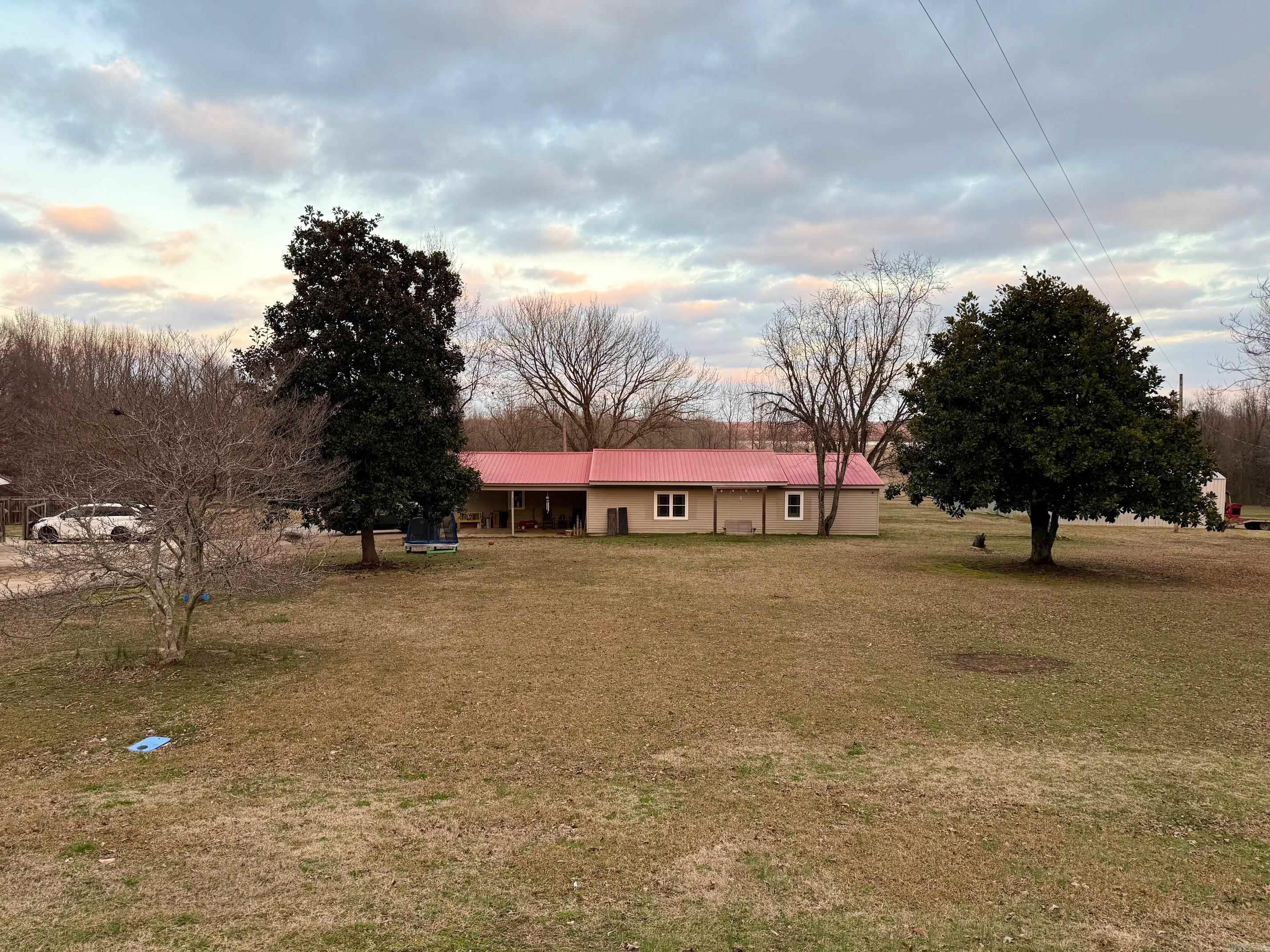 This charming 4-bedroom, 2-bathroom home is situated on 3.24 acres of picturesque land along Beautiful Bay Road, just minutes from Wynne and Cherry Valley. Tastefully updated throughout, this home features a spacious living room with vaulted ceilings and a bright, modern kitchen with sleek cabinetry and appliances. Originally a manufactured home, thoughtful additions have transformed it into a custom-style retreat. The master bath boasts a stunning walk-in tiled shower and double vanity for a touch of luxury. Additional amenities include a 20x25 shop, a convenient carport, and a paved driveway. The property offers incredible value at this price point! Don't miss your chance to own this beautiful country retreat!