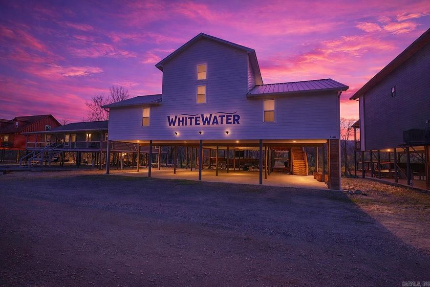 Looking for a riverfront cabin in Arkansas that sleeps 14 and is ready to rent? Welcome to 146 Serenity Loop in Glenwood, AR, known as “Whitewater” cabin overlooking the Caddo River, a rare luxury riverfront cabin that works as both a short-term vacation rental and a true home away from home. If you want a fully furnished cabin on the Caddo River with space for large groups, and this one delivers with 4 bedrooms each with ensuite baths, plus a bunk room with a full bath, comfortably sleeping up to 14 guests. Life here feels easy and relaxed: wake up to river views, sip coffee on the 1,500 sq ft wraparound deck overlooking the water, spend afternoons floating the Caddo, and enjoy evenings in the game room or large living room with family and friends. The home offers an eat-in kitchen, separate dining room, and a fully stocked kitchen with two ovens, two microwaves, two large islands, and a coffee bar, making entertaining simple. The lower level features additional seating and a deck overlooking the river, while covered parking underneath, two washer and dryer sets, and a dedicated owner’s closet add convenience for owners and guests. All furnishings and décor convey.