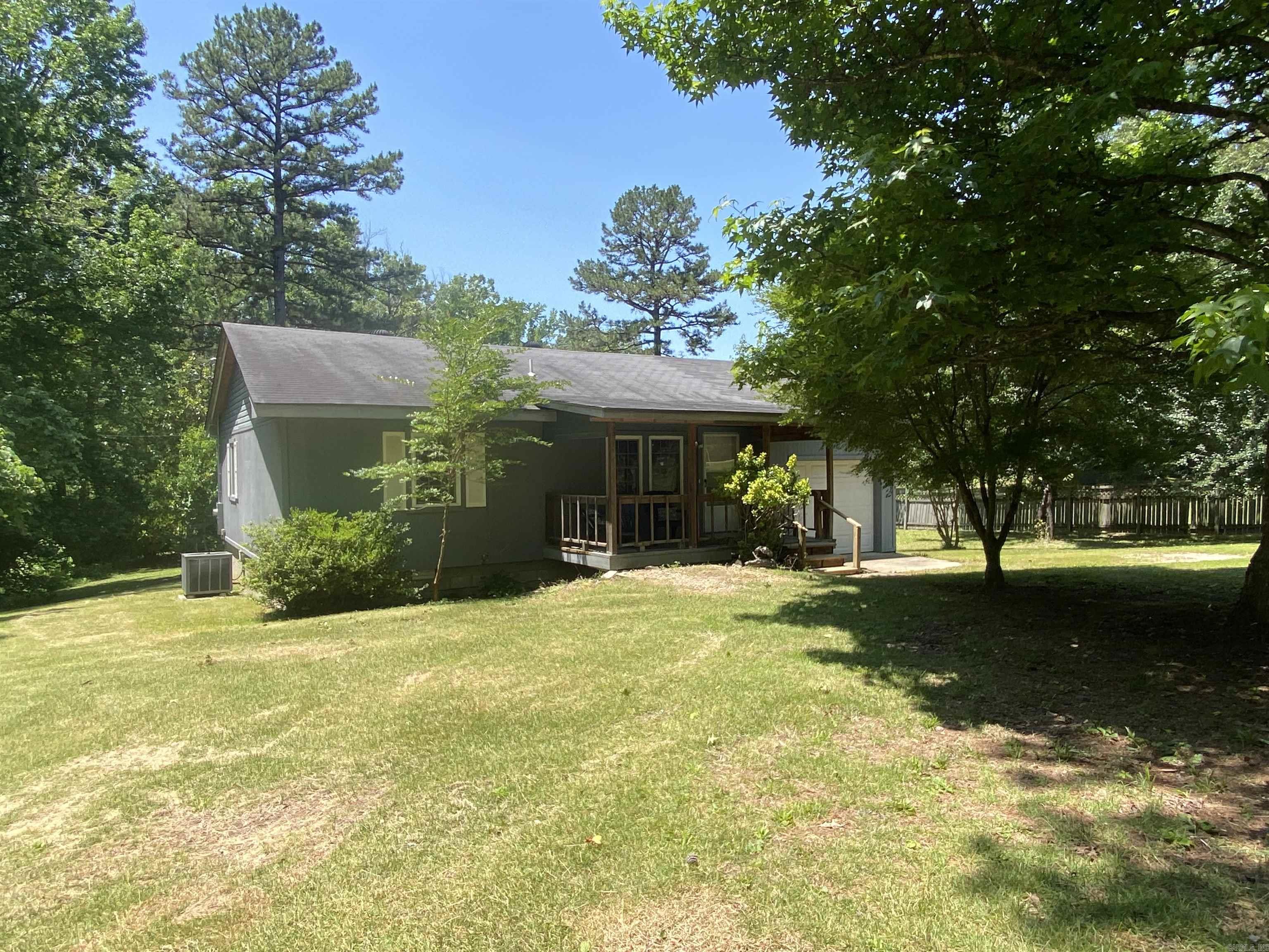 Get ready for Lake Ouachita! Enjoy all the summer has to offer in this 2 bedroom, 1.5 bath home in Twin Creek Landing! The property features 1.41 acres m/l (4 lots) with a detached garage/shop building and lean-to, outside storage area, two propane tanks, screened in back porch, and an extra RV hookup. The RV hookup has access from the road behind the property without driving thru the middle of your manicured yard. There are some large shade trees and a very healthy magnolia tree also! Inside, you will enjoy the spacious open area that includes the kitchen and living area included in the 1044 square feet. The kitchen has beautiful bamboo flooring and all the modern conveniences for your "Lake House". Off the large laundry room, there is a one car attached garage. Twin Creek launch area is a nice spot to launch your boat and you are less than 1/2 mile to launch! Lots of National Forest land nearby and the Lake is calling you! Places in the historic area of Twin Creek do not come along very often, so setup your appointment today! $179,900.00