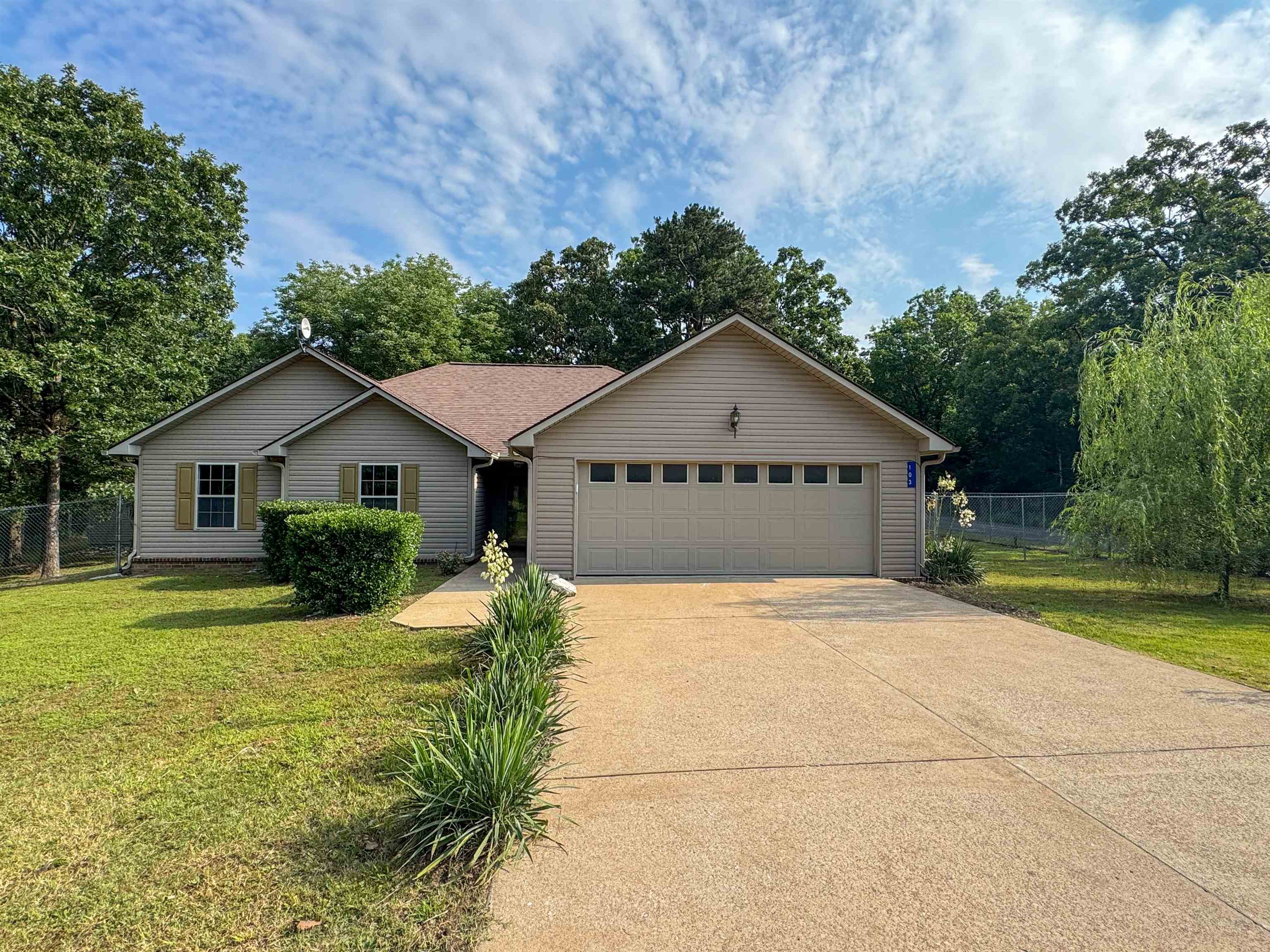 Enjoy space, privacy, and convenience with this beautifully updated 3 bed, 2 bath home on 1.8 acres—just 1 mile from Cave City Elementary. Thoughtfully landscaped and surrounded by mature trees, this property offers a peaceful setting just minutes from town. Inside, you'll find 1,595 sqft of freshly painted living space with brand-new carpet and an inviting layout. The living room features a tiled fireplace with electric insert, and the dining area includes a bay window overlooking the fenced backyard. The kitchen comes equipped with stainless steel appliances—washer, dryer, and fridge all convey. The spacious primary suite includes his and hers walk-in closets, dual vanities, a jetted tub, and a separate shower. Guest bedrooms also offer walk-in closets. Outside, enjoy a covered patio, freshly painted deck, 6’ chain-link fence, and a detached shed with electricity, a garage door, and workbench. The attached, true 2-car garage includes two storage closets. Families will appreciate the highly rated Cave City School District, known for small class sizes, award-winning campuses, a 95% graduation rate, and strong college and career prep with AP and gifted programs.