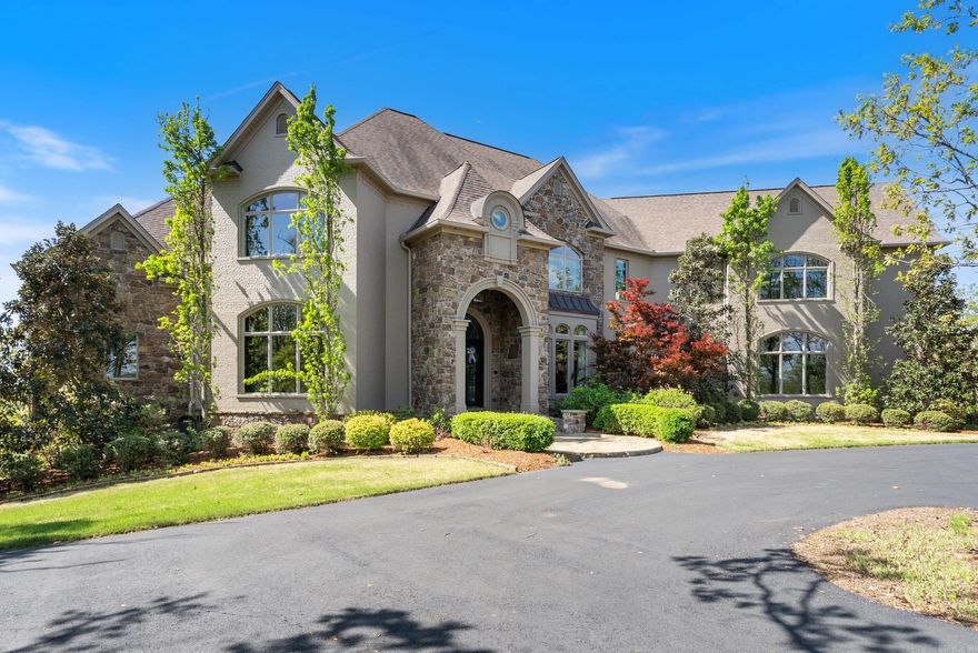 From the moment you arrive, this world-class estate offers a private retreat, where nature and sweeping views create a sense of tranquility. Step through the custom iron front door into a striking foyer where a floating staircase, handcrafted iron railings & rich walnut floors set the tone for the craftsmanship found throughout the home. The kitchen is designed to bring people together, with Schonbeck chandeliers, quartzite countertops, marble backsplashes & reclaimed wood beams creating a warm, elevated atmosphere. A Thermador double refrigerator & freezer, 60-inch range with double ovens & generous prep space make hosting effortless. A butler’s pantry, working pantry & three distinct dining areas add both function and flexibility. The primary suite is a peaceful escape, inspired by St. Mark’s Square in Venice. Heated marble floors, a steam shower, refined lighting & a custom closet with an island create a spa-like experience at home. Throughout the estate, thoughtful surprises await, including secret rooms, tunnel slides, a second kitchen, a second laundry, and two three-car garages. Every detail reflects exceptional craftsmanship. This home is as livable as it is unforgettable.