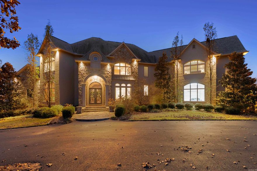 From the moment you arrive, this world-class estate offers a private retreat, where nature and sweeping views create a sense of tranquility. Step through the custom iron front door into a striking foyer where a floating staircase, handcrafted iron railings & rich walnut floors set the tone for the craftsmanship found throughout the home. The kitchen is designed to bring people together, with Schoenbeck chandeliers, quartzite countertops, marble backsplashes & reclaimed wood beams creating a warm, elevated atmosphere. A Thermador double refrigerator & freezer, 60-inch range with double ovens & generous prep space make hosting effortless. A butler’s pantry, working pantry & three distinct dining areas add both function and flexibility. The primary suite is a peaceful escape, inspired by St. Mark’s Square in Venice. Heated marble floors, a steam shower, refined lighting & a custom closet with an island create a spa-like experience at home. Throughout the estate, thoughtful surprises await, including secret rooms, tunnel slides, a second kitchen, a second laundry, and two three-car garages. Every detail reflects exceptional craftsmanship. This home as livable as it is unforgettable.