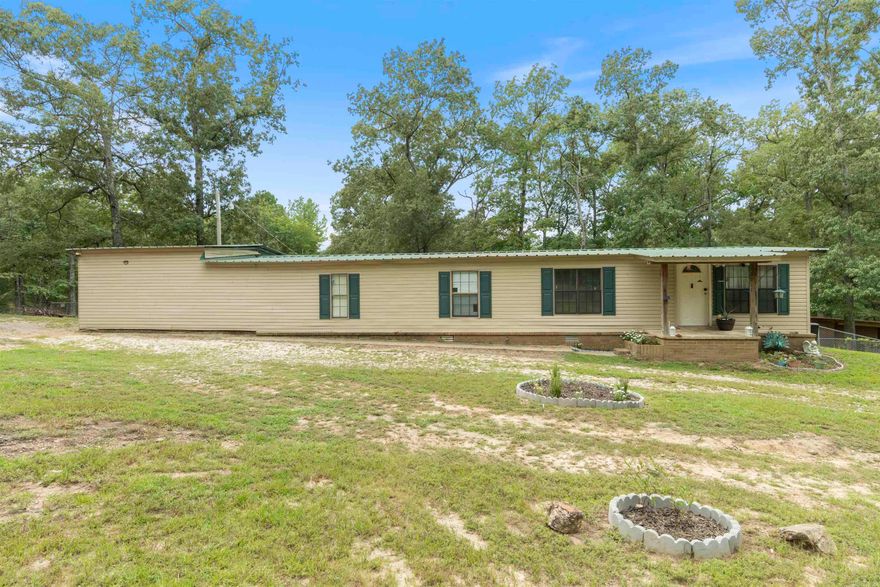 Unrestricted corner lot with an updated 3 bedroom 1 bath home. It has a unique attached 2 car garage with additional storage, large family room, deck with new stairs and railing. The bathroom has been renovated this summer (2025). The expansive lot has a pool, RV parking with independent septic (RV stays) outdoor storage and tons of room for outdoor recreation like riding ATVs and four wheelers, bonfires, and more! All appliances convey except for a standing deep freezer