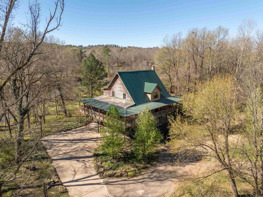 Welcome to 483 Boulder Road, with approx 8.34 acres & approx 387 feet of waterfront on the Mazarn creek. You'll enter this 3,069 sq ft home & be wowed by the gorgeous wooden walls, floor, & ceiling surrounding you. On the main level you'll find the living room, great room & dining room, half bath, laundry room & spacious kitchen w/ a double oven, solid surface countertops, a lovely view of the water, & much more. Follow the stairway, adorned with beautiful ironwork, upstairs to find 4 bedrooms & 3 full baths. Closets are cedar lined, & the vaulted ceiling is magnificent. Imagine yourself sitting outside on a rainy day, listening to the rain and relaxing on the covered deck that wraps completely around the house. So much room for entertaining & for parking with a 4 car garage & 4 covered spaces just outside. Fully fenced area in the backyard allows pets to come in & out safely through pet door in garage. Dog bath in garage makes cleaning up very convenient. Another convenience is the lift outside making the house handicap accessible. Launch your canoe right from the backyard & enjoy a lovely ride down the Mazarn. This would make a fantastic short term rental or primary residence!