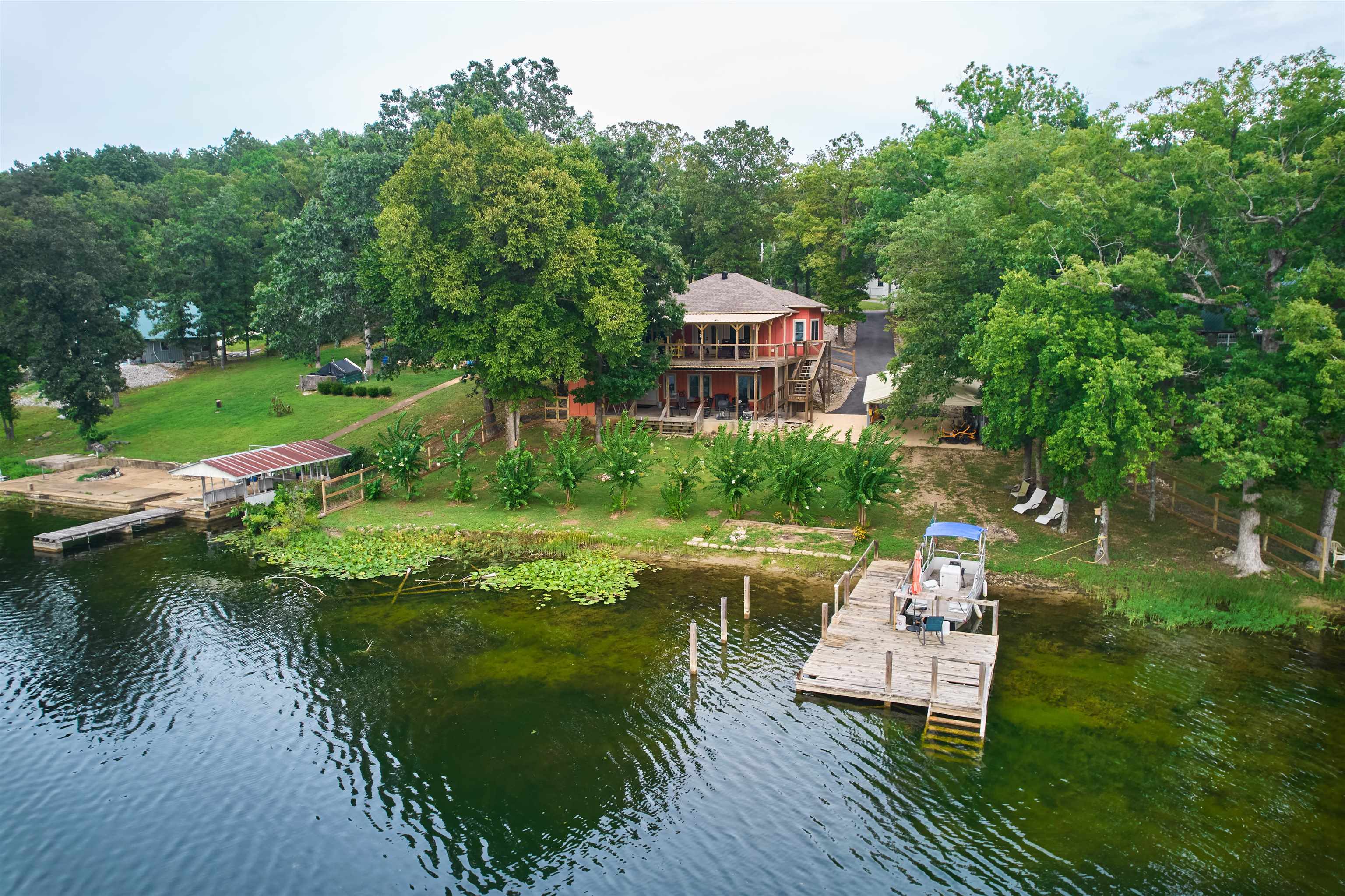 LAKE SHERWOOD waterfront bungalow with Outstanding views! Located in "Spring River Country" in Hardy AR. Get the best of both worlds at this well sought after location. Pontoon boat included!! Home features 2 Bd 2 Ba split level living if you are looking for a guest retreat or mother-in-law suite. Open floor plan on the main level with high end wood looking tile flooring on both levels. Large and spacious bathrooms with extra large walk-in shower en-suite and lower level has large shower with jetted tub! TWO gas fireplaces with stone surround. Walk out main floor covered deck for entertaining. Don't forget the generous safe ground when needed. Lake Sherwood is a private recreation spring fed lake for skiing, tubing, paddleboarding & other lake activities. Extra large carport for two vehicles! Matching storage shed and paved driveway! Super cute curb appeal! Pride of ownership very well maintained!!Live like you're on Vacation EVERYDAY!