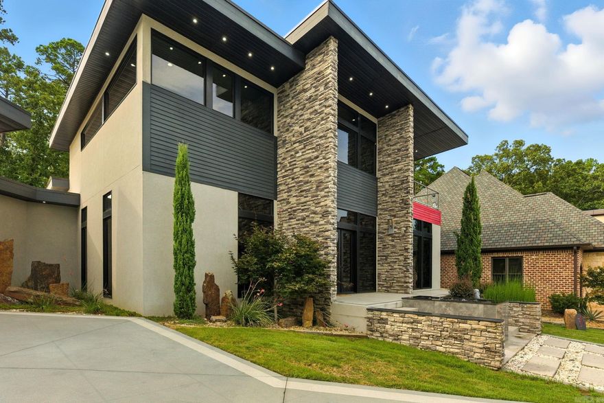 31 La Scala Court is a modern masterpiece where stone, metal, and glass converge in flawless harmony. A striking fountain sets the stage for the double-door entry, opening to soaring ceilings and walls of glass. At the heart of the home, a chef’s kitchen showcases a 17-foot waterfall island, sleek custom cabinetry, and integrated appliances. A stunning custom staircase rises to a versatile bonus room and two guest suites connected by a unique shared suite bath with private vanities and toilets. The owner’s suite is a retreat unto itself with a cozy sitting area, office nook, and a spa-worthy bath overlooking the serene backyard water feature. The boutique-style custom closet connects seamlessly to the laundry room for convenience and ease. Every inch reflects exquisite attention to detail, from dramatic architectural elements to thoughtful design choices. Set on a premier lot in a gated cul-de-sac, this residence is offered for the first time ever. This is an unparalleled opportunity to own a work of art that embodies modern luxury and timeless design. For those who demand the extraordinary, this is the home that defines it. Yearly dues cover lawn care.