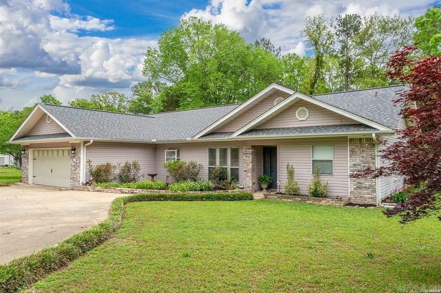 LAKE HAMILTON lakefront living with private boardwalk and peaceful inlet views in the desirable Lake Hamilton School District! this update one level home in Hot Springs, Arkansas offers an open-concept floor plan connecting the kitchen, dining, living area, and sunroom.  Ideal for entertaining and everyday comfort.  Enjoy 3 bedrooms, 2 bath with a functional 1819 sqft layout. Outdoor living with a spacious deck overlooking the water, plus a permitted boardwalk and deeded lake access for kayaking, fishing and easy boat pickup on Lake Hamilton. Kitchen includes abundant counter space, pull-out shelving, gas cooktop and updated appliances.  LVP flooring runs throughout.  UPDATES:  HVAC 2020, ROOF 2025. A detached 2-car garage and shop provide excellent space for storage, lake toys, & workshop.