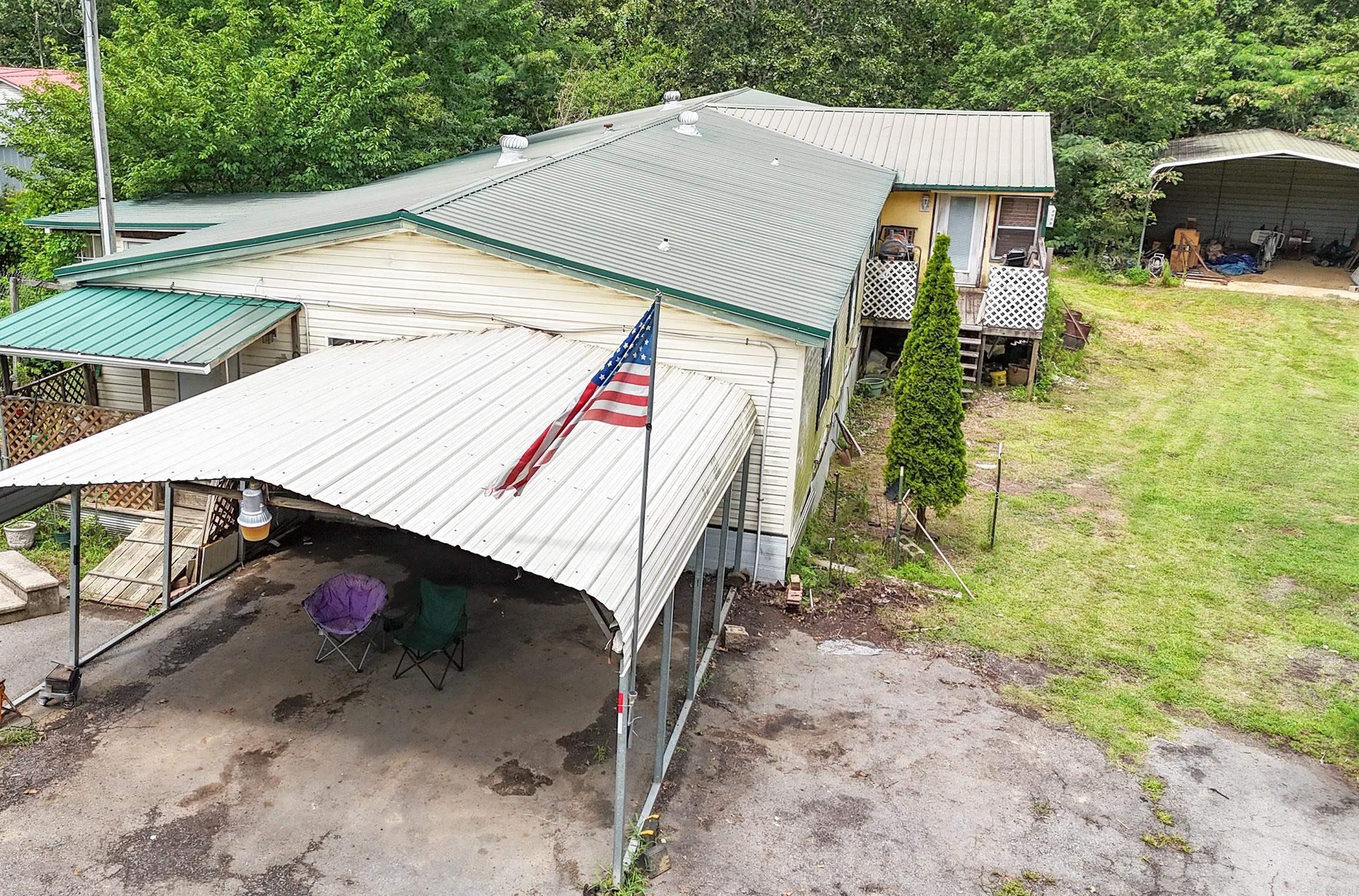 Looking for space, privacy, and potential? This property has it all. Situated on 1.7 acres and tucked behind a gated entrance, this manufactured homeāwith two additionsāoffers room to spread out and make it your own. One addition features a bright and inviting sunroom, while the other expands the living area and includes a dedicated office. Inside, youāll find an enormous kitchen with a walk-in pantryāperfect for anyone who loves to cook or entertain. With a bit of paint, new flooring, and HVAC repair, this could be a fantastic place to call home or a great investment opportunity. Outside, the property is fully fenced and includes multiple carports, a dog run, and several outbuildingsātwo with electricityāgiving you endless options for storage, hobbies, or workshop space. Priced to sell quickly and sold as-is. Bring your vision and unlock the potential!