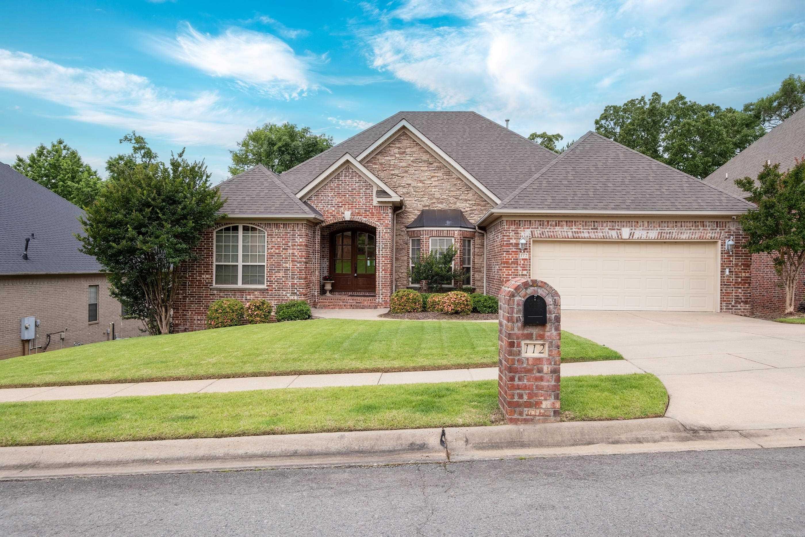 This entertainer's dream home at 112 Blackburn Drive offers large open spaces with a living room featuring built-ins, a grand fireplace, 10ft ceilings, and a wall of windows overlooking the pool and dedicated greenspace. The chef's kitchen boasts a gas range, 2024 dishwasher, double oven, built-in microwave, and a large island with ample storage. Enjoy a spacious eat-in breakfast area, formal dining with 13 ft ceilings, and a 2-car garage with sink. The main level includes a laundry room, the primary suite with a large walk-in shower, double walk-in closets, two vanities, and a whirlpool tub, as well as the spacious guest suite. Upstairs, a covered deck overlooks the pool, while the downstairs offers a second living area with stained concrete floors, a wet bar, and a third bedroom with a walk-in closet and full bath. Beautiful landscaping surrounds the inviting pool, with plenty of storage in the crawlspace. Come make this your home today!