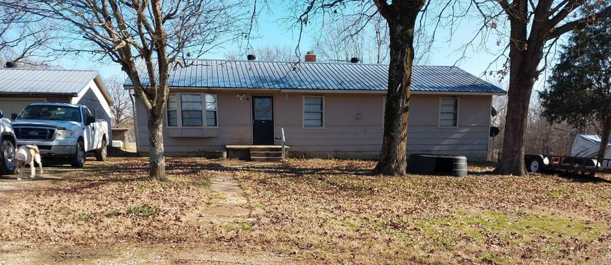 Rustic Home on 15 Acres!!!  This home features 4 spacious bedrooms and 2 full bathrooms - one of which was updated in 2023. Large living room. Kitchen and dining combo with newer stove. Large laundry room. Back deck with a sprawling view of the property and the large pond. Fruit trees. Detached one car garage. Out building with electric. 1456 square foot. Located just 10 miles from Pocahontas!