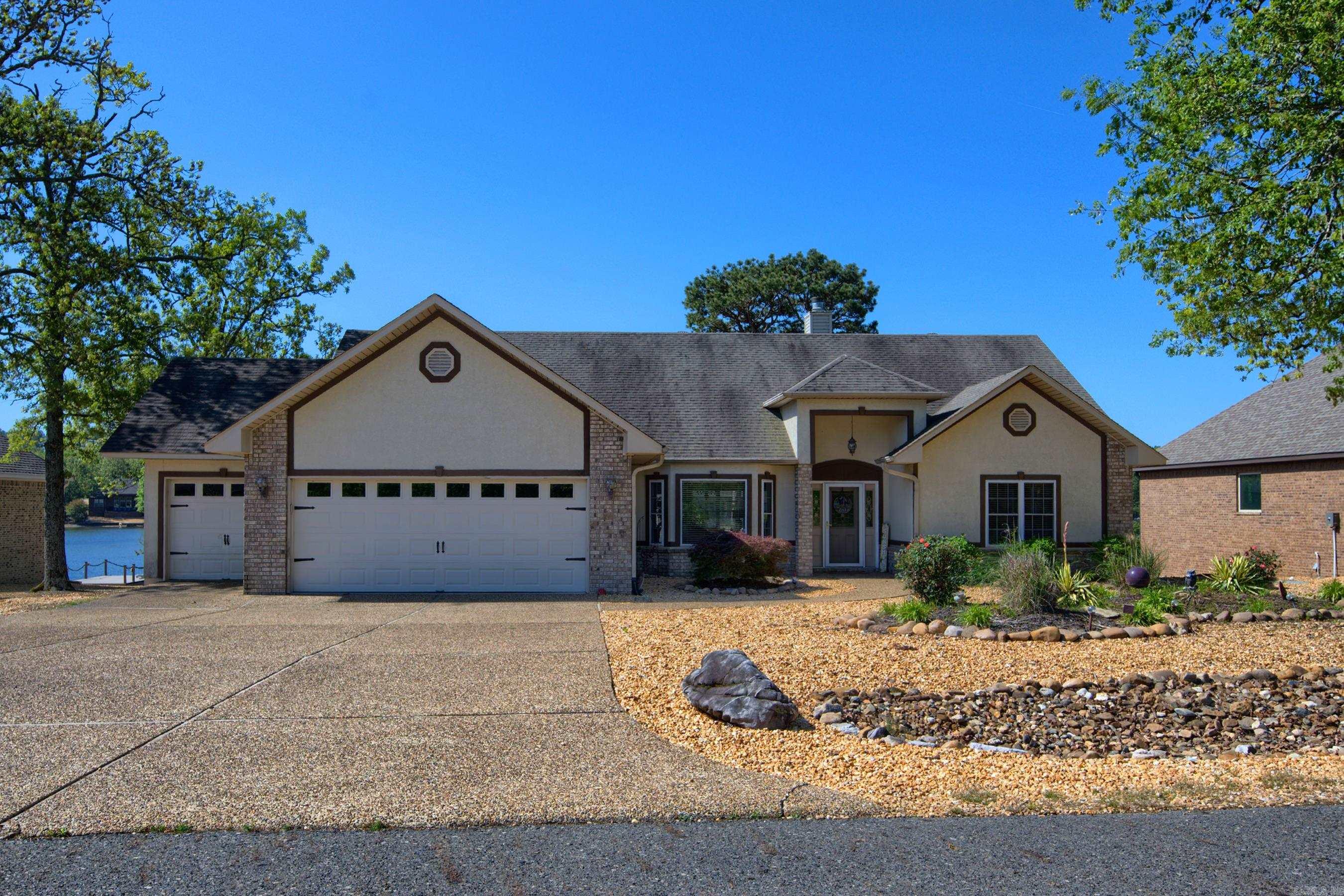JUST WHAT YOU HAVE BEEN LOOKING FOR! This is a beautiful three bedroom, two bath home on an exclusive street, in an upscale neighborhood on the desirable East Village area of Hot Springs Village. Enjoy the view of Lake Maria from sitting on your deck or take a dip off the attached swim dock for most of the year, and the massive gas fireplace which dominates the living room for those cozy winter nights. Plenty of room for your toys in the three car garage, and a partially fenced yard gives your puppies a place to rest and play as well. This house is located on a dead-end street for reduced traffic and is nestled in the midst of luxury homes which enhances the home's value. Come and fall in love with this home at your earliest convenience.