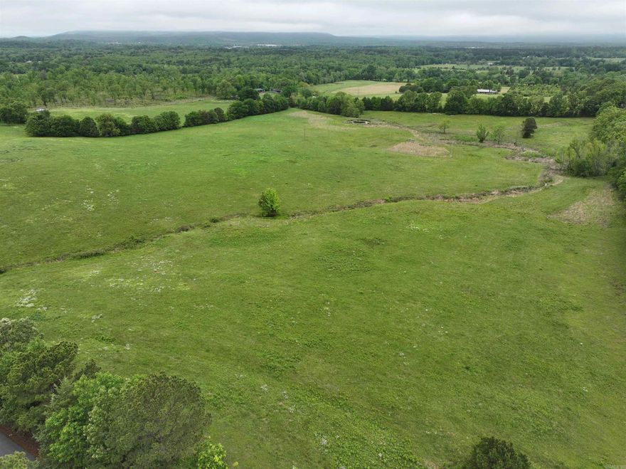 Seize a rare opportunity on this 40 acre parcel with breathtaking mountain vistas and multiple premium building sites. The property includes two ponds, rural water already on-site, and access to other utilities. Mobiles allowed. Close to the airport and ideal for a private estate, small development, or multiple homes — ample space and versatility for a range of plans.