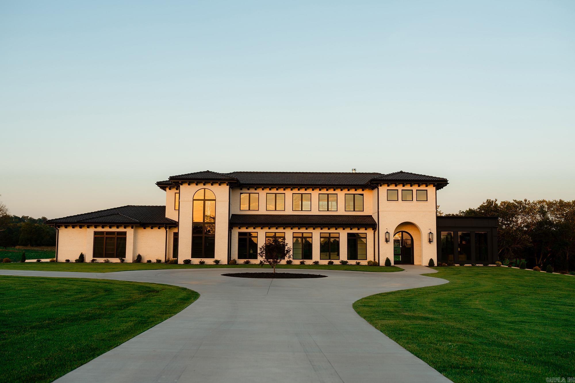 This luxury custom home with 5 bedrooms, 5.5 bathrooms can accommodate a large family or host guests comfortably. Offering impressive architectural elements, high end Quartzite countertops, top of the line appliances, thoughtful storage solutions, custom cabinetry which create a functional yet seamlessly sophisticated look. Other amenities include two washers/dryers in the laundry room, convenient mud room, and central vac. The home is designed with accordion glass doors for seamless connectivity of the indoor and outdoor living spaces for effortless entertaining. The covered patio overlooks a heated pool, a spa, a view of a small lake, and 39+ acres. Bathrooms feature custom tiled showers, stone countertops, quality fixtures & finishes throughout. Large bedrooms boast ample storage with walk-in closets. This one of a kind, luxury home was designed to provide an unparalleled living experience, with upscale amenities, in a picturesque setting, yet close to town.
