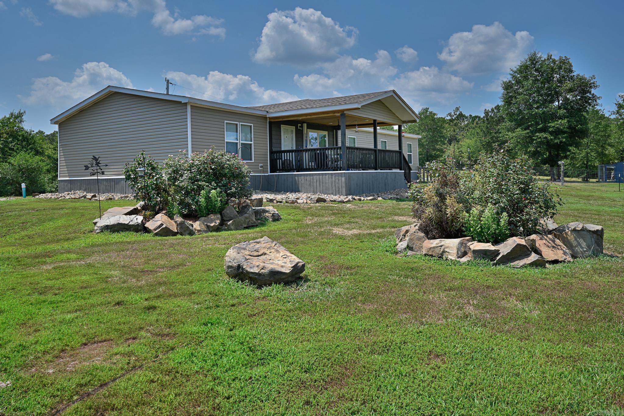 Welcome to your own slice of paradise in the country! This spacious 2020 Boujee XL manufactured home offers 4 bedrooms & 3 bathrooms, all set on a permanent foundation. Nestled on 17.31 acres, this home blends modern upgrades with peaceful rural charm. Open living/kitchen/dining, with a large kitchen island, great for entertaining. Featuring a coffee nook & a cozy electric fireplace in the den that's perfect for cold days. Recent upgrades include a new roof, siding, porches & underpinning, giving the home a fresh look. Outside, you'll find a garage with concrete floor, electric, a storage loft & lean-to, offering plenty of room for tools, toys & hobbies. A large barn with two roll-up doors adds even more space for storage or equipment. Enjoy the natural setting with a seasonal creek, wildlife sightings & a pond (in need of a little TLC). Thereās also a chicken coop, ideal for those wanting to enjoy fresh eggs or start a small hobby farm. Start your mornings on the front porch, where you can sip your coffee and watch the sunrise over the mountains for a view that never gets old.