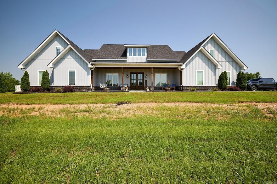 Welcome to this exquisite craftsman-style residence nestled within the serene Kentucky Hills Subdivision on a sprawling 13.35-acre lot. This exceptional property features five spacious bedrooms, including two primary suites, and 3.5 well-appointed bathrooms. The interior boasts 3,656 square feet of beautifully designed living space. The main living area is adorned with elegant LVP flooring, while each bathroom is meticulously finished with stylish tile. The centerpiece of the home is the inviting main bedroom which features a luxurious custom-tiled shower, a large sunken tub, dual vanities, and a generously sized walk-in closet. Entertain effortlessly in the gourmet kitchen equipped with a 5-burner gas stove, leathered granite countertops, a vast island, a Frigidaire  Professional Double Door refrigerator, and double ovens. The living room, complete with a cozy gas fireplace, offers a perfect blend of comfort and charm, complemented by an office/flex space and a separate laundry room. The outdoor living is just as impressive, featuring a covered back porch with an integrated kitchen grill, ideal for outdoor gatherings. Additional amenities include a 30 x 40 shop. SEE AGENT REMARKS.