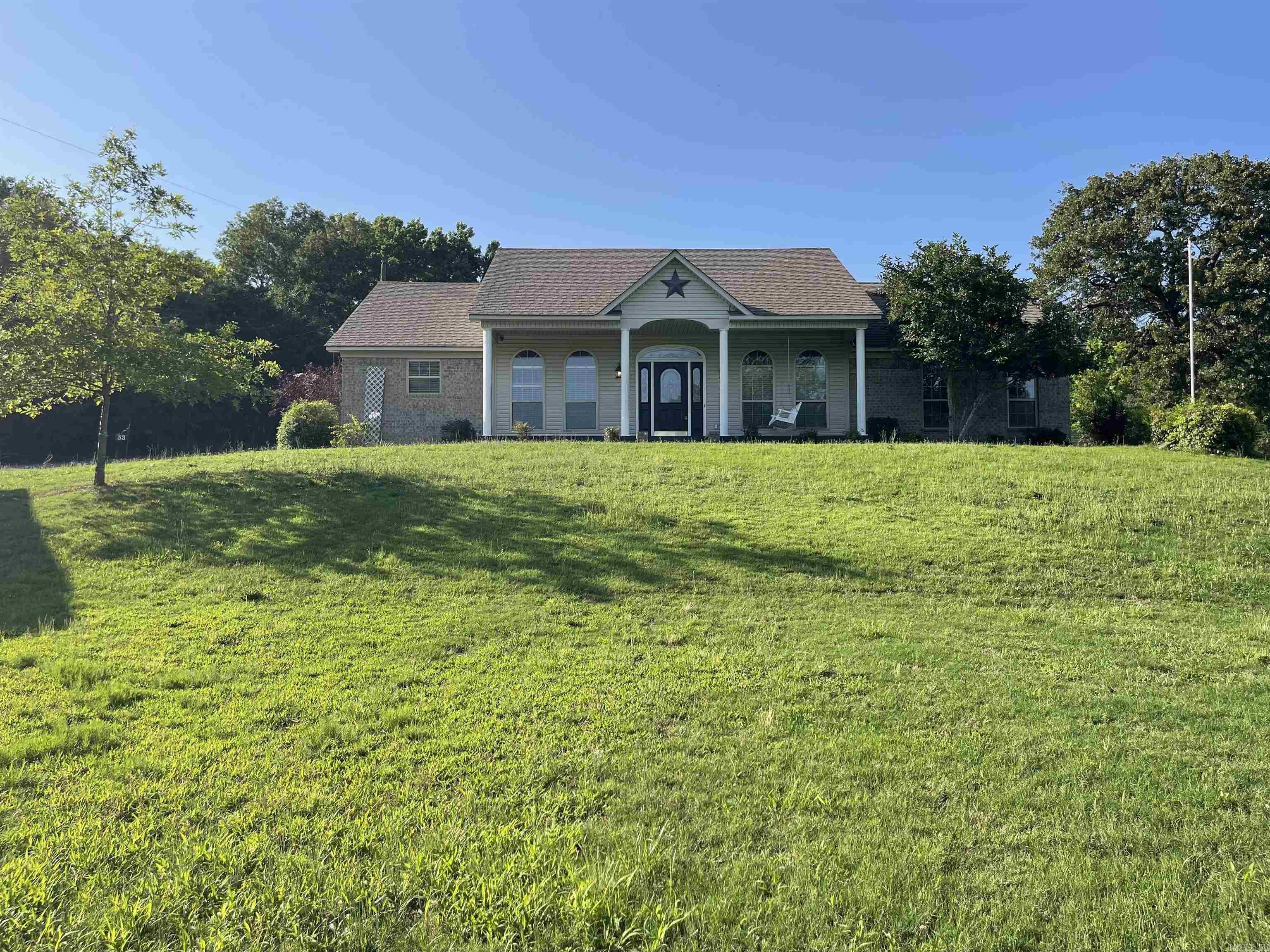 Welcome to this beautifully maintained 3 bed, 2 bath home on 1.53 acres with over 1,860 SF of comfortable living space! The spacious entryway opens to a large living room featuring a cozy wood-burning stove and direct access to a screened-in back patio—perfect for relaxing or entertaining! Patio is overlooking your professionally installed above-ground pool for those hot summer days. The open-concept kitchen includes new stainless steel appliances, ample cabinetry, and flows seamlessly into both formal and casual dining areas. Oversized bedrooms each feature walk-in closets. The primary suite offers a walk-in shower, separate soaker tub, and a generous closet. You’ll love the large laundry room with extra storage as well. Enjoy a 2-car attached garage, two storage sheds, and custom metal carports—including oversized boat cover and a tall RV cover with electric hookup. Plenty of space for all your toys, hobbies, and guests. Located just minutes from town, this property has it all!