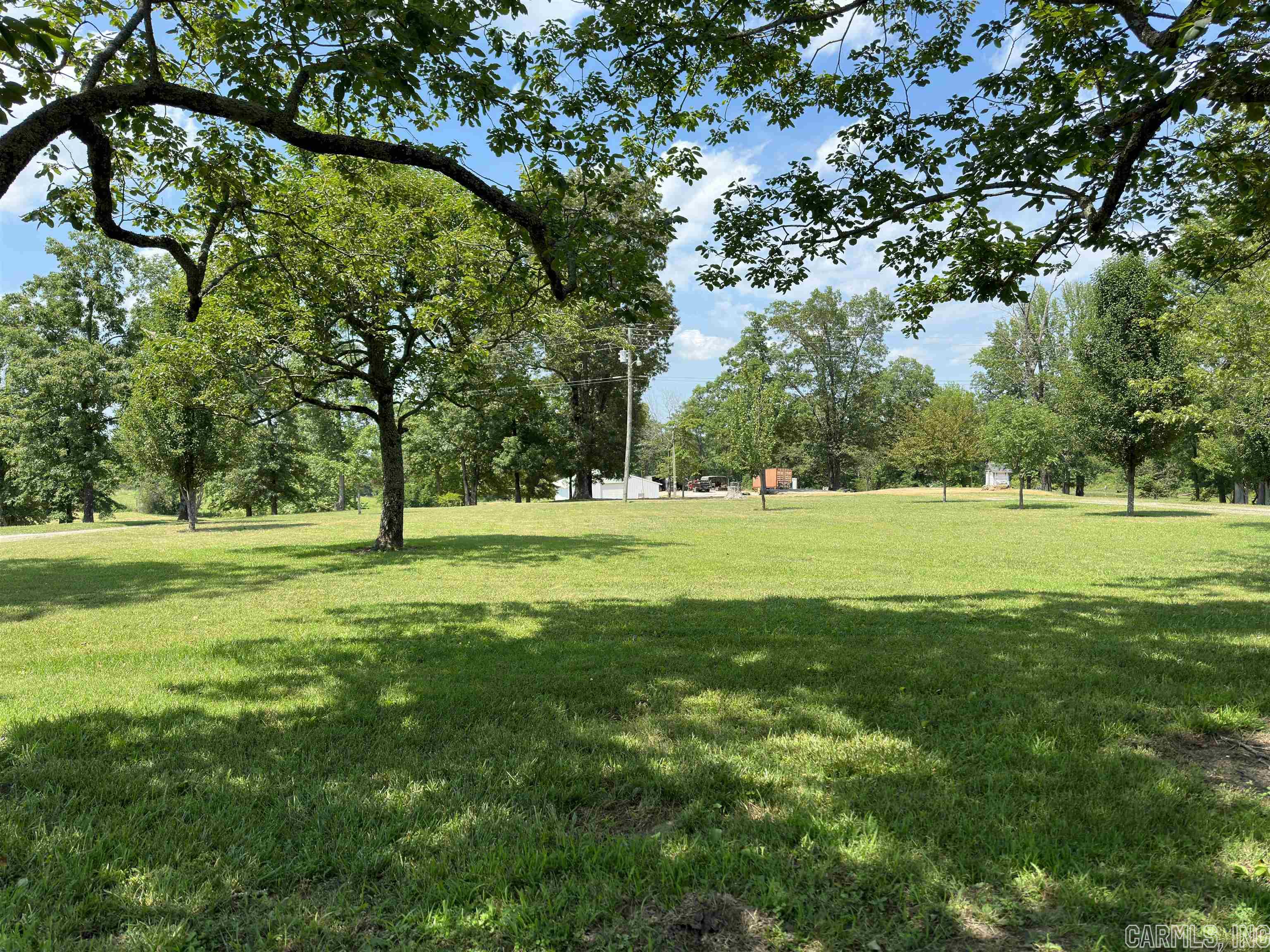 MOTIVATED SELLER!!! You will find this property surrounded by mature trees as you enter the circle drive. Great spot for livestock or use part of the acreage for a hay field. So many possibilities with this acreage. You will find a 42x72 shop for all your toys or equipment, a pond and not to mention the perfect spot to build your dream home. This property has 600’ of highway frontage and it is cleared and ready to go. Current survey available. Call today to tour this property!