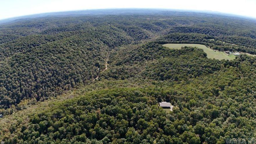 Private 205 acres m/l storm proof retreat – 2 bedroom, 2 bath, low maintenance home. Escape to your own secluded paradise on 205 acres m/l of pure privacy adjoining Jimmy’s Creek. This unique property is built to last with solid concrete walls and designed for stormproof safety, featuring a built-in safe room and bomb blast windows for ultimate peace of mind and maintenance free for easy living. This is more than a home, it’s a fortress of comfort and privacy. Ideal for hunting or a secure homestead. Only an hour from Branson MO and 15 minutes to the closest boat launch on Bull Shoals Lake.