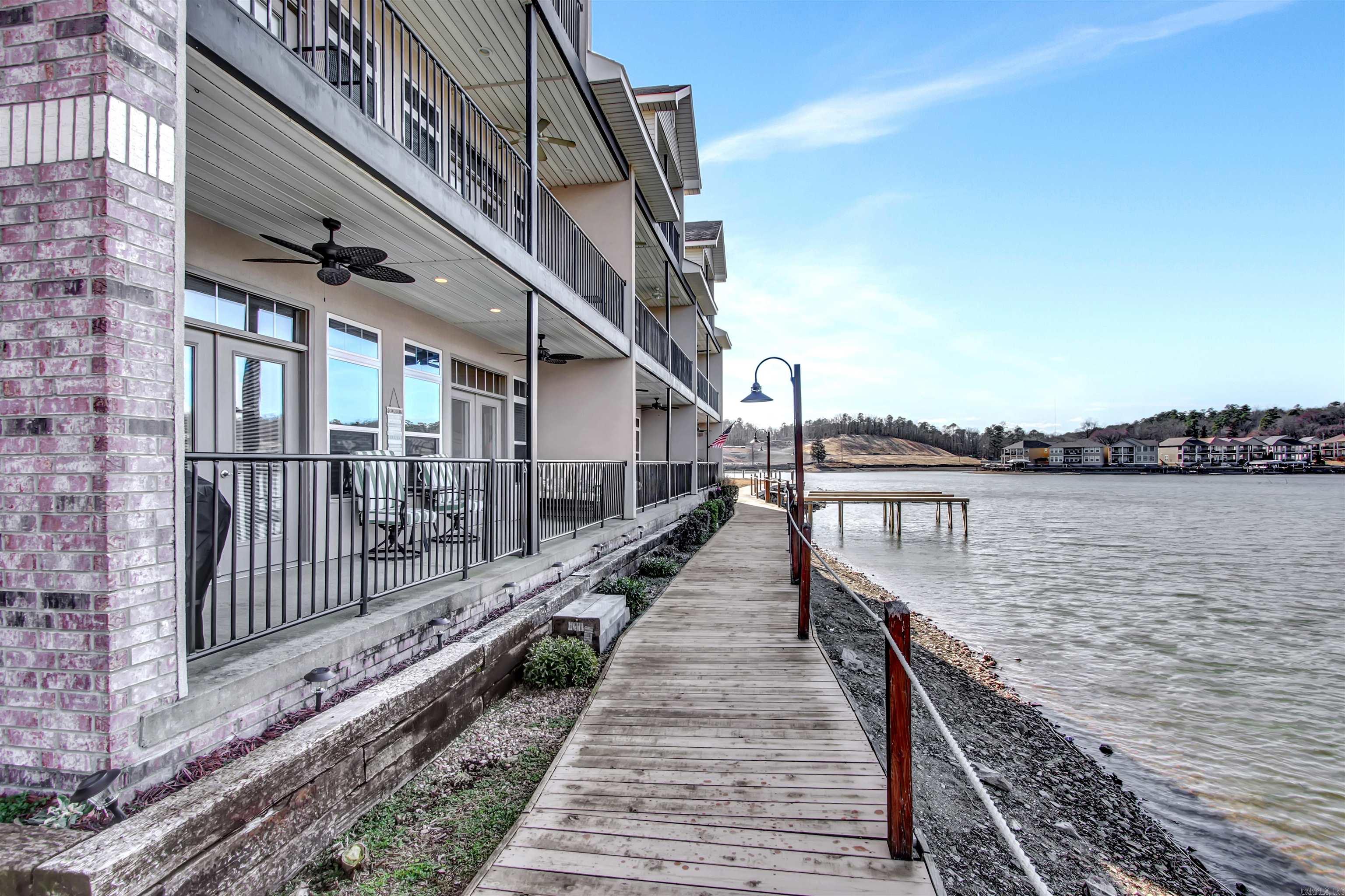 Lakefront living at it's finest! Your own private pennisula awaits you in this small condo complex. Lakeviews in every direction. The well appointed 2 bedroom comes fully furnished. Short term rentals are allowed here so you invested minded buyers keep that in mind. You can enjoy your personal time here and have it income producing. The best of both worlds. Enjoy the level entry and your private garage as well!