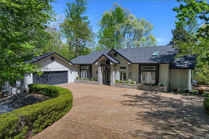 Bright, airy Lake Balboa home with a million dollar view. Located on a wooded cul-de-sac and and at the end of an open cove this home comes with the quiet and safety of being in a cove, but with the open channel view looking directly across the lake at Balboa beach and the fireworks from ground to sky. With few exceptions every room in this home has a lake view and the massive owner's suite boasts his and hers walk-in closets. The kitchen is open concept and has nicely appointed appliances with both a formal dining area and a breakfast nook. Aside from the formal living area there is a second, informal area with a gas fireplace. Downstairs is another living area with a wet bar, two large bedrooms and a large multi-purpose room with a separate, outside, entrance. Outside this home has mature landscaping and a flat back yard from the house to the lake with a fire pit, covered patio and floating boat slip. Exterior lighting in both the back and front of the home add to it's understated elegance.