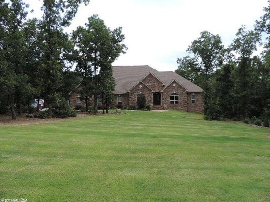 Custom in every way! Wood and tile floors throughout, private office, hearth room off kitchen, chef's kitchen with built in fridge, walk-in pantry, spectacular master suite with great master bath, workout room and bonus room downstairs, great covered deck, storage galore, surround sound and security system, granite tops. (See agent remarks.)