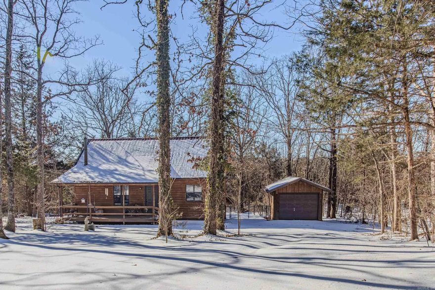 Here's the cozy cabin in the woods you're looking for! Sitting on 10 acres m/l, this home has a wood burning stove, metal roof, sunroom, 20' beamed ceiling, with loft & open floor plan, and detached garage! You'll love never leaving the pavement from a county road, to the driveway! Wildlife abounds in this oasis of peace & quiet! Brown rubberized chain link fence in the back will keep the pets safe and is aesthetically pleasing. Home has been well maintained and cared for. No carpet in the house! 2 full bathrooms downstairs and in the loft. This is an amazing property for hunting, homesteading, and living a peaceful and content life!